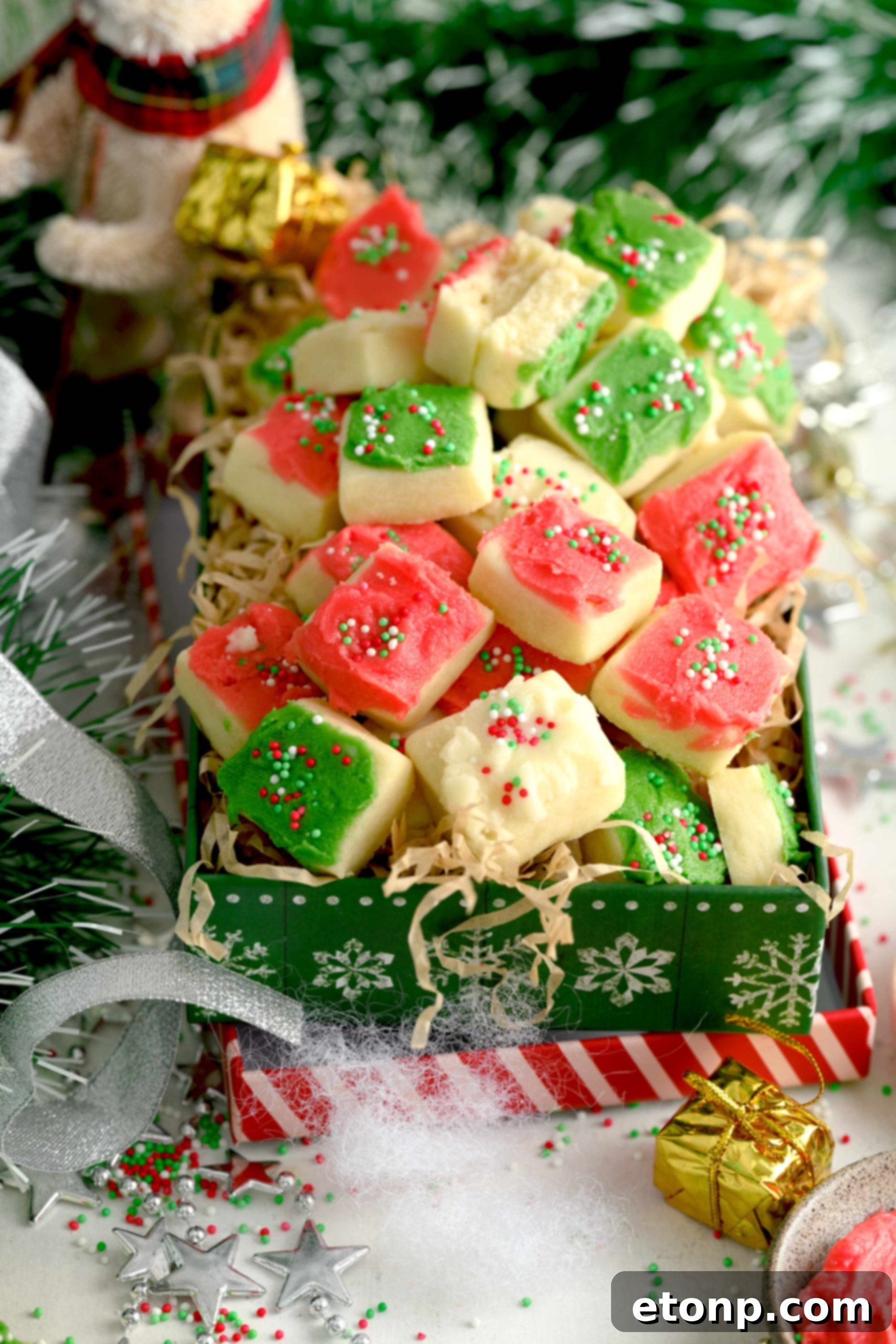 A close-up of several red, green, and white frosted Christmas Sugar Cookie Bites, highlighting their appealing texture.