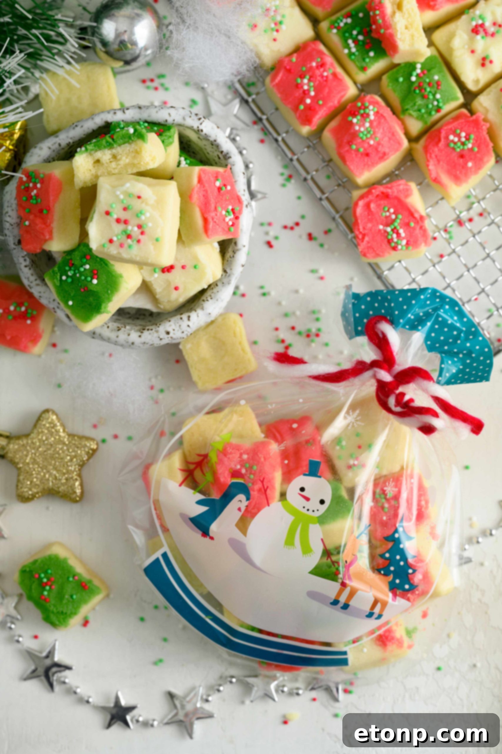 Christmas Sugar Cookie Bites with red and green frosting and sprinkles arranged on a festive plate.
