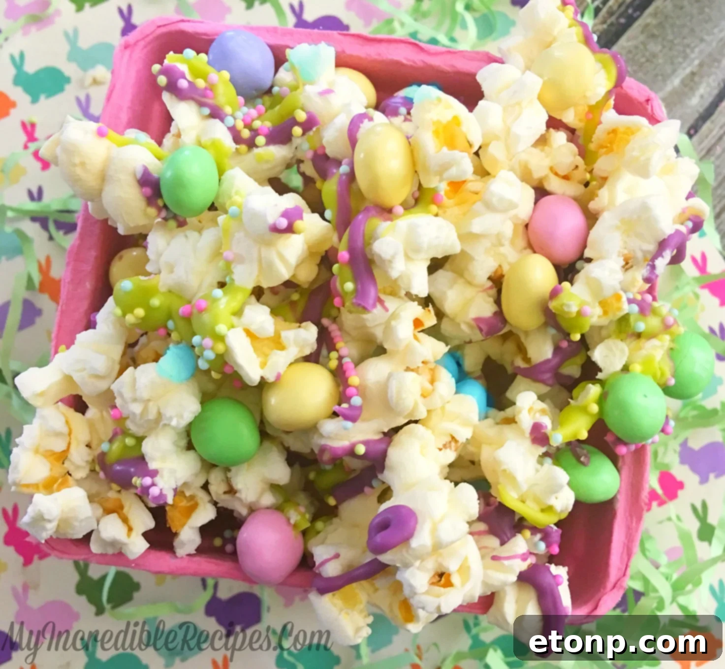Deliciously festive Bunny Bait snack, piled high with colorful candies and chocolate drizzles