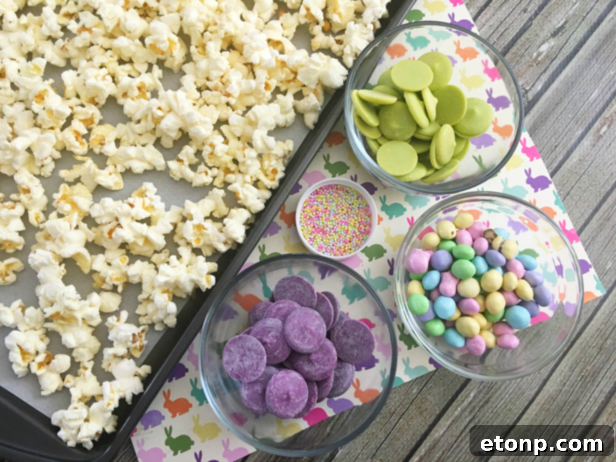 Close-up of Bunny Bait with pastel M&Ms and sprinkles, showing crunchy popcorn coated in chocolate