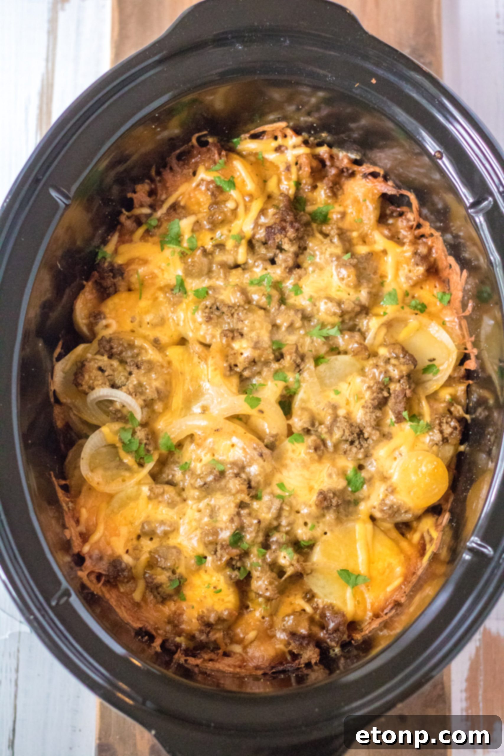Delicious Slow Cooker Beef and Potato Au Gratin, a cheesy and hearty dish ready to be served.