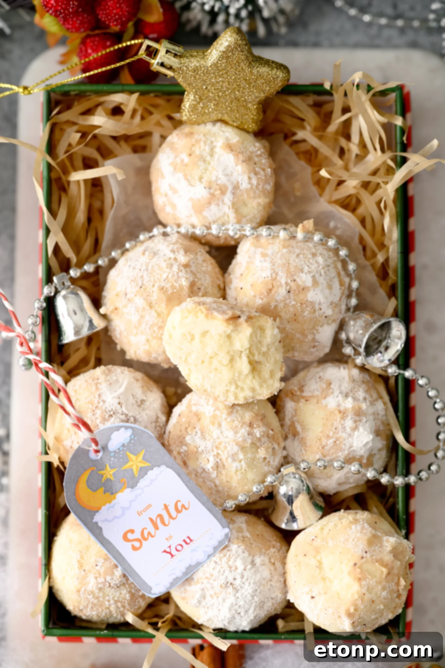 A baking tray filled with round cookie dough balls, lightly dusted with cinnamon sugar, ready to be baked into delicious Cinnamon Mexican Wedding Cookies.
