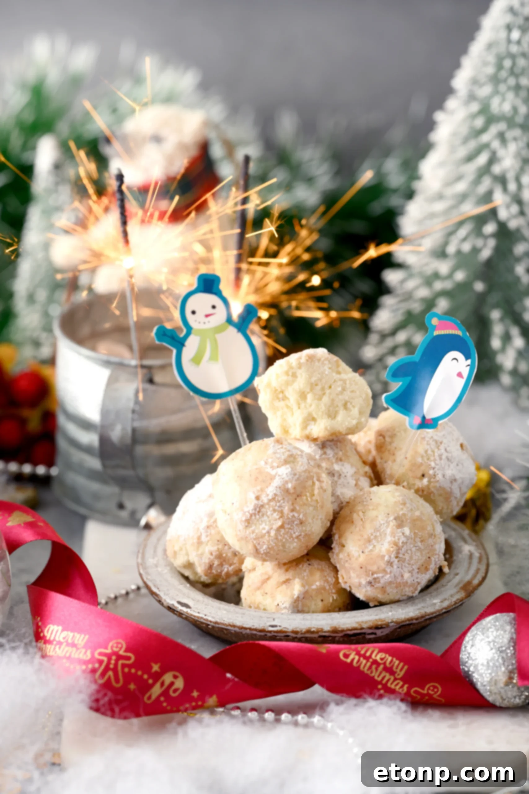 A hand gently tossing freshly baked Cinnamon Mexican Wedding Cookies in a bowl filled with cinnamon-dusted powdered sugar, ensuring a thorough coating.