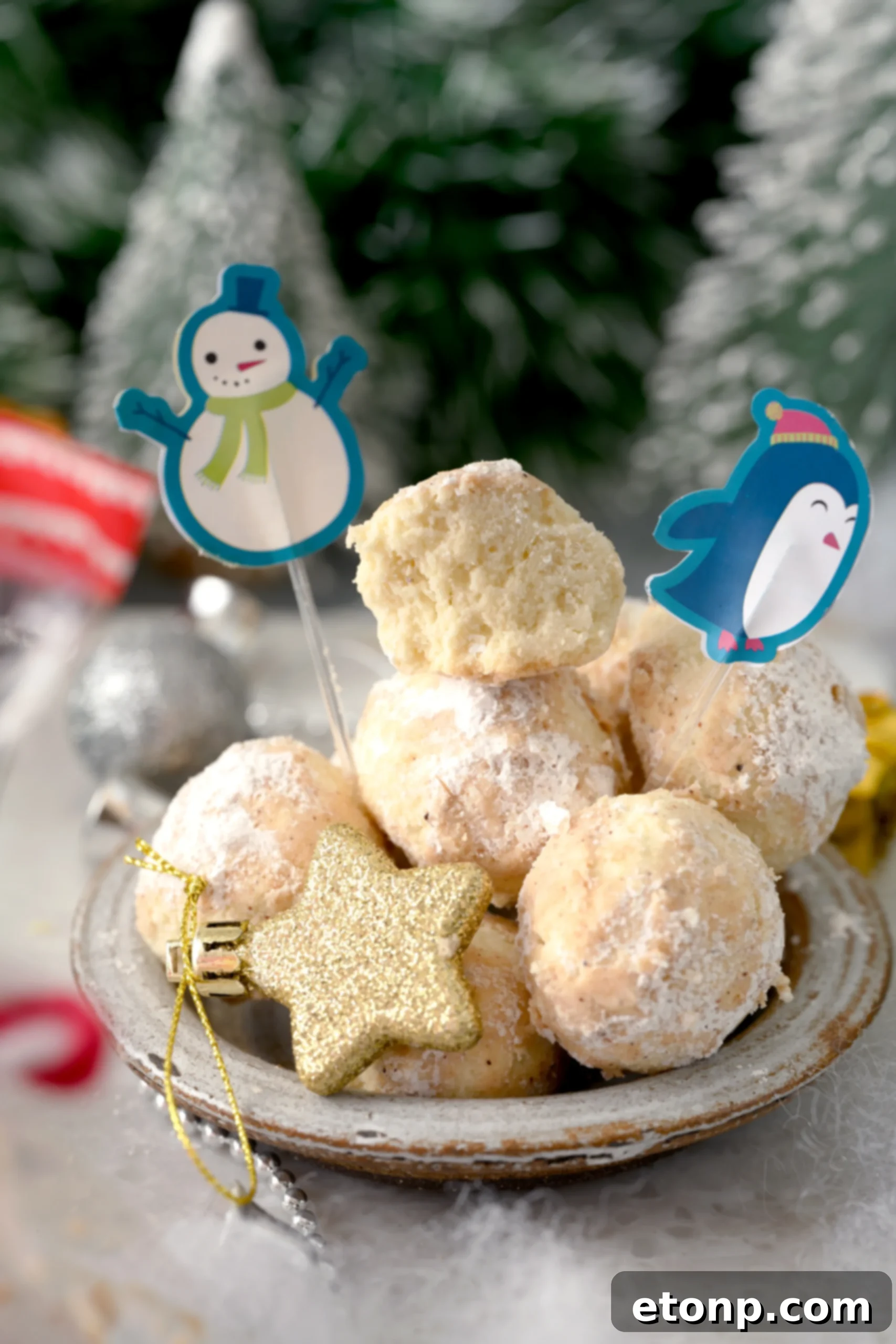 A stack of Cinnamon Mexican Wedding Cookies in a clear, airtight glass container, illustrating proper storage for freshness.