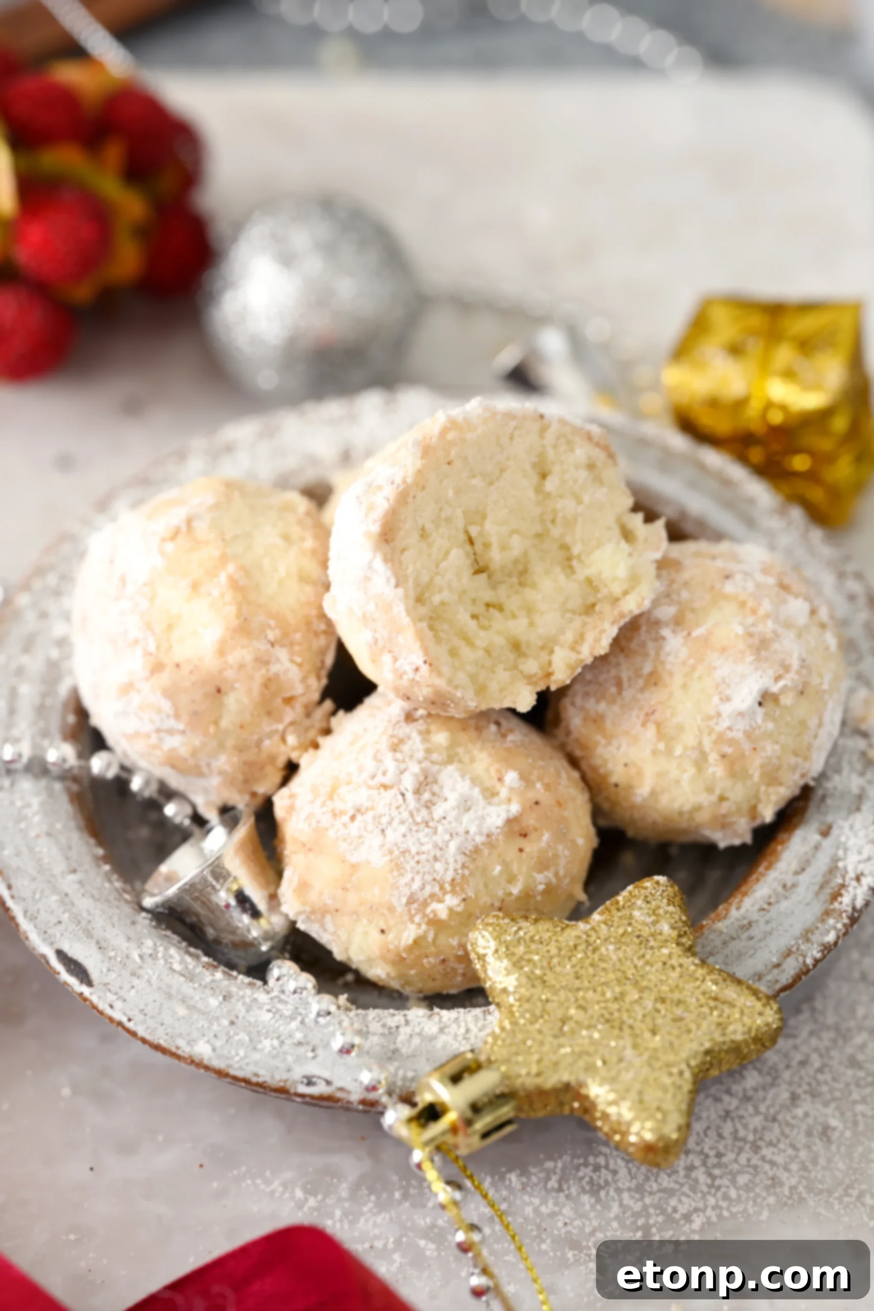 A generous pile of Cinnamon Mexican Wedding Cookies, beautifully coated and ready to be enjoyed, suggesting a delicious and satisfying dessert experience.