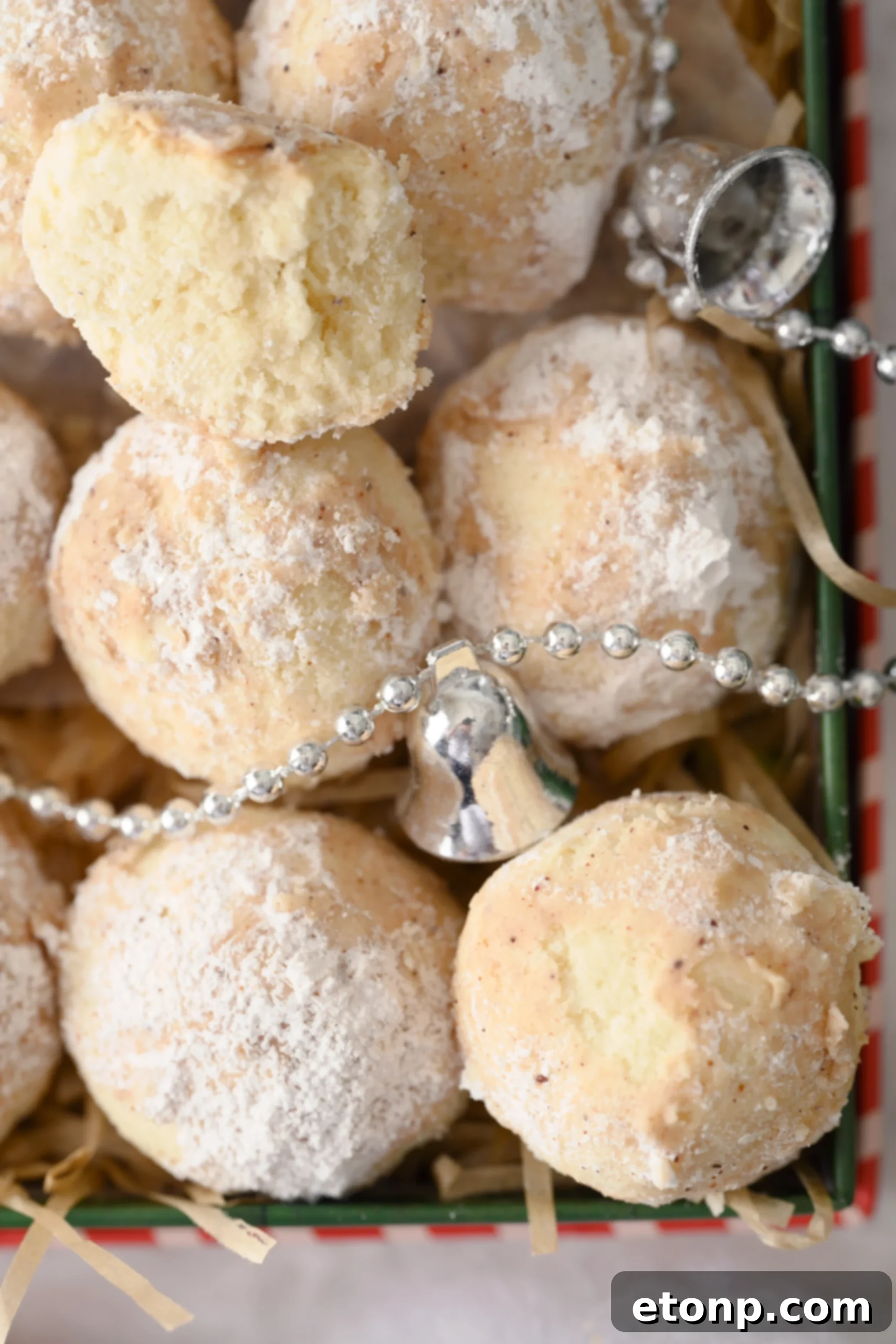 Two Cinnamon Mexican Wedding Cookies stacked, beautifully coated in cinnamon-dusted powdered sugar, with a subtle cinnamon stick in the background, enhancing the spice theme.