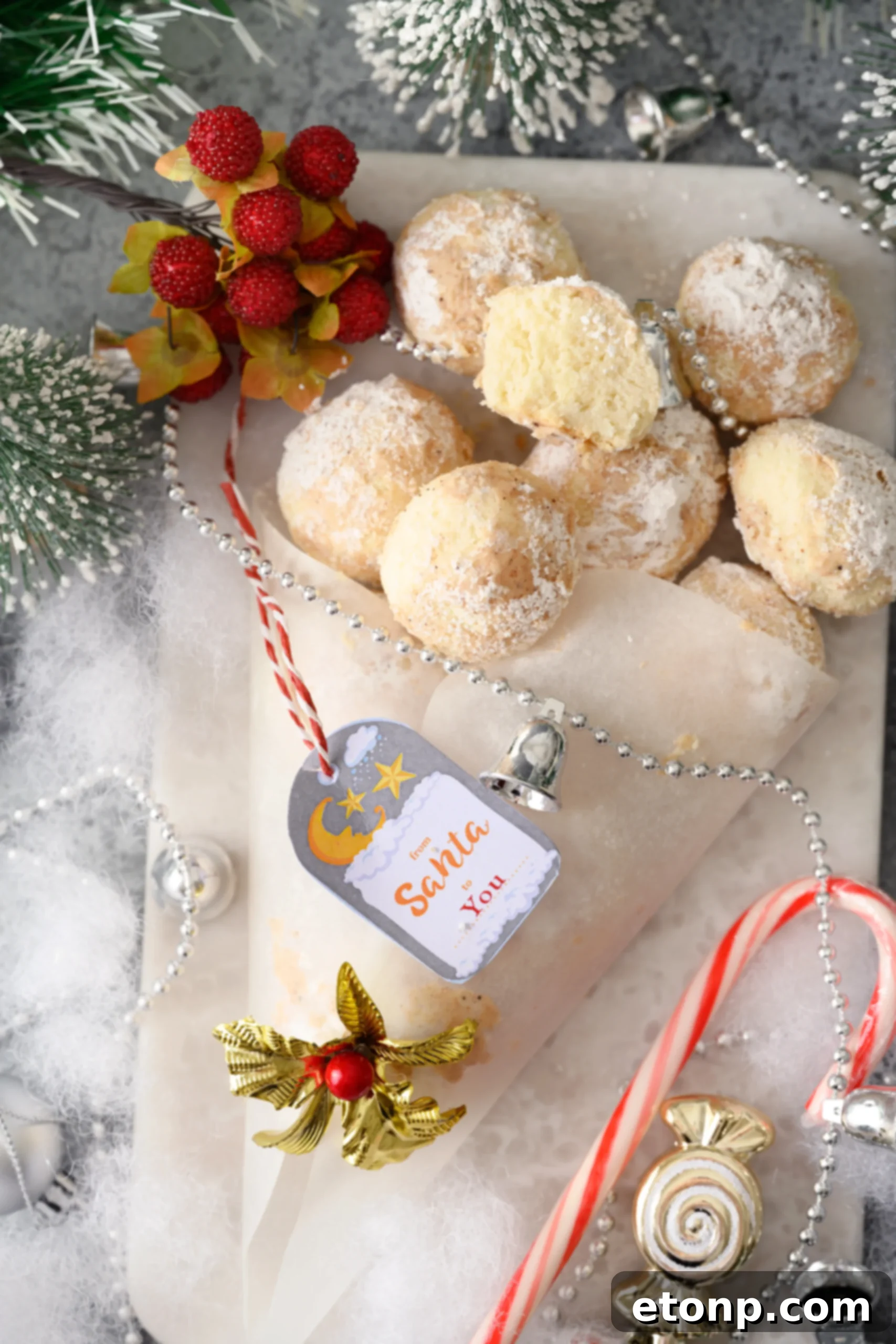 A top-down view of Cinnamon Mexican Wedding Cookies, showcasing their uniform shape and generous coating, arranged on a baking sheet with parchment paper.