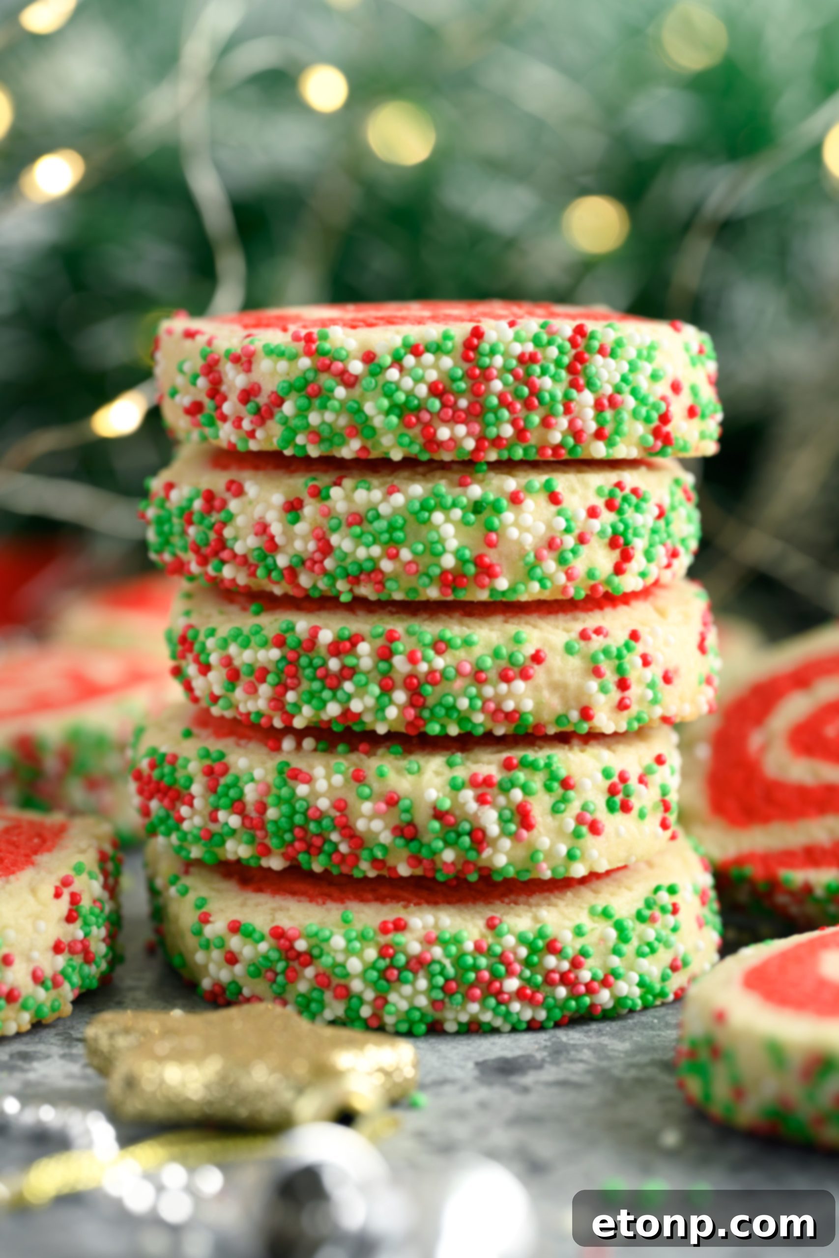 Yuletide Swirl Delights 6 Pinwheel cookie dough being rolled with sprinkles