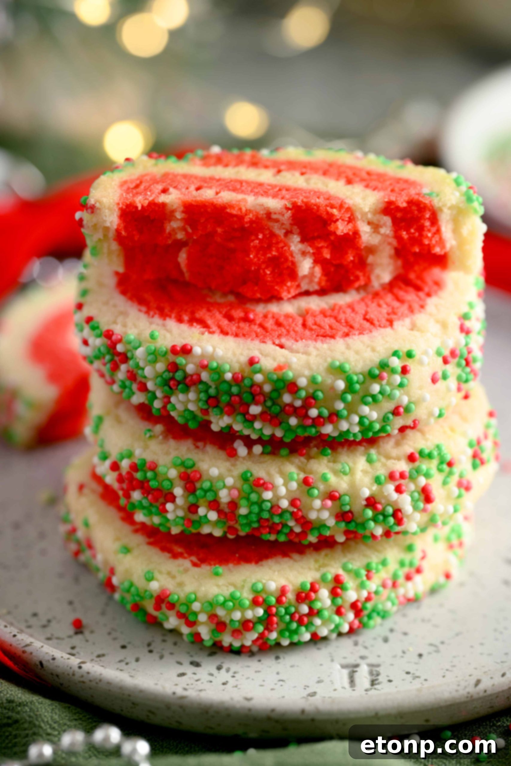 Yuletide Swirl Delights 8 Baked Christmas Pinwheel Cookies on a wire rack with glaze