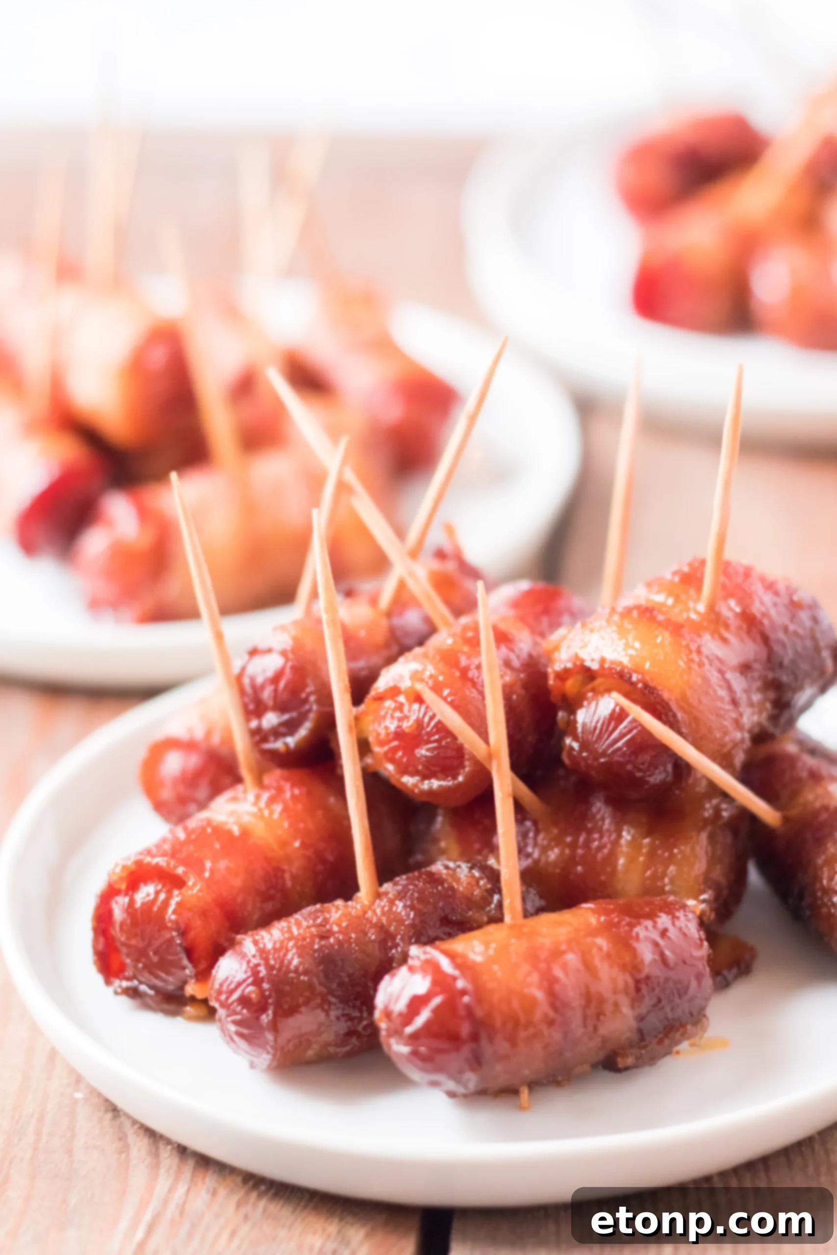 Crock-Pot Candy Bacon Smokies 2 Slow Cooker Bacon Wrapped Smokies arranged in a slow cooker, ready to be cooked to perfection.