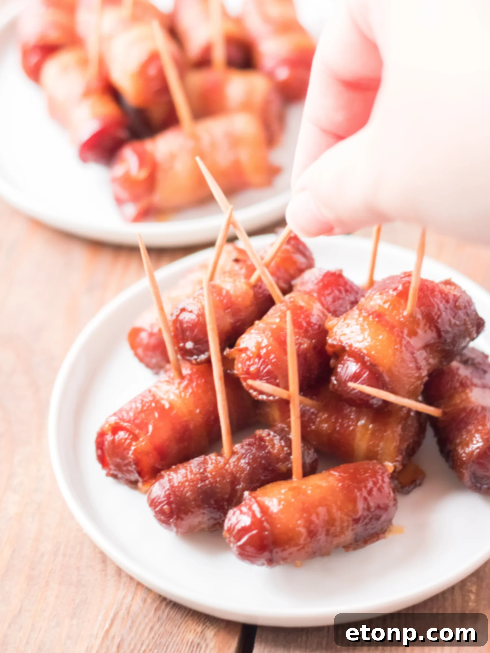 Crock-Pot Candy Bacon Smokies 12 Assortment of Slow Cooker Bacon Wrapped Smokies, showing their rich, sticky coating.