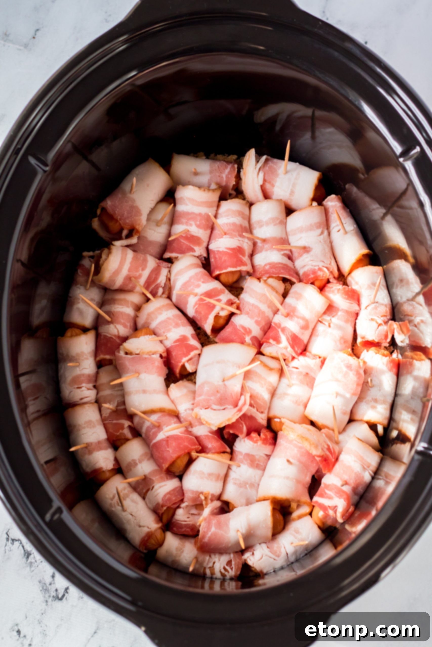 Crock-Pot Candy Bacon Smokies 4 A bowl of uncooked 'Lil Smokies' cocktail sausages, ready for preparation.