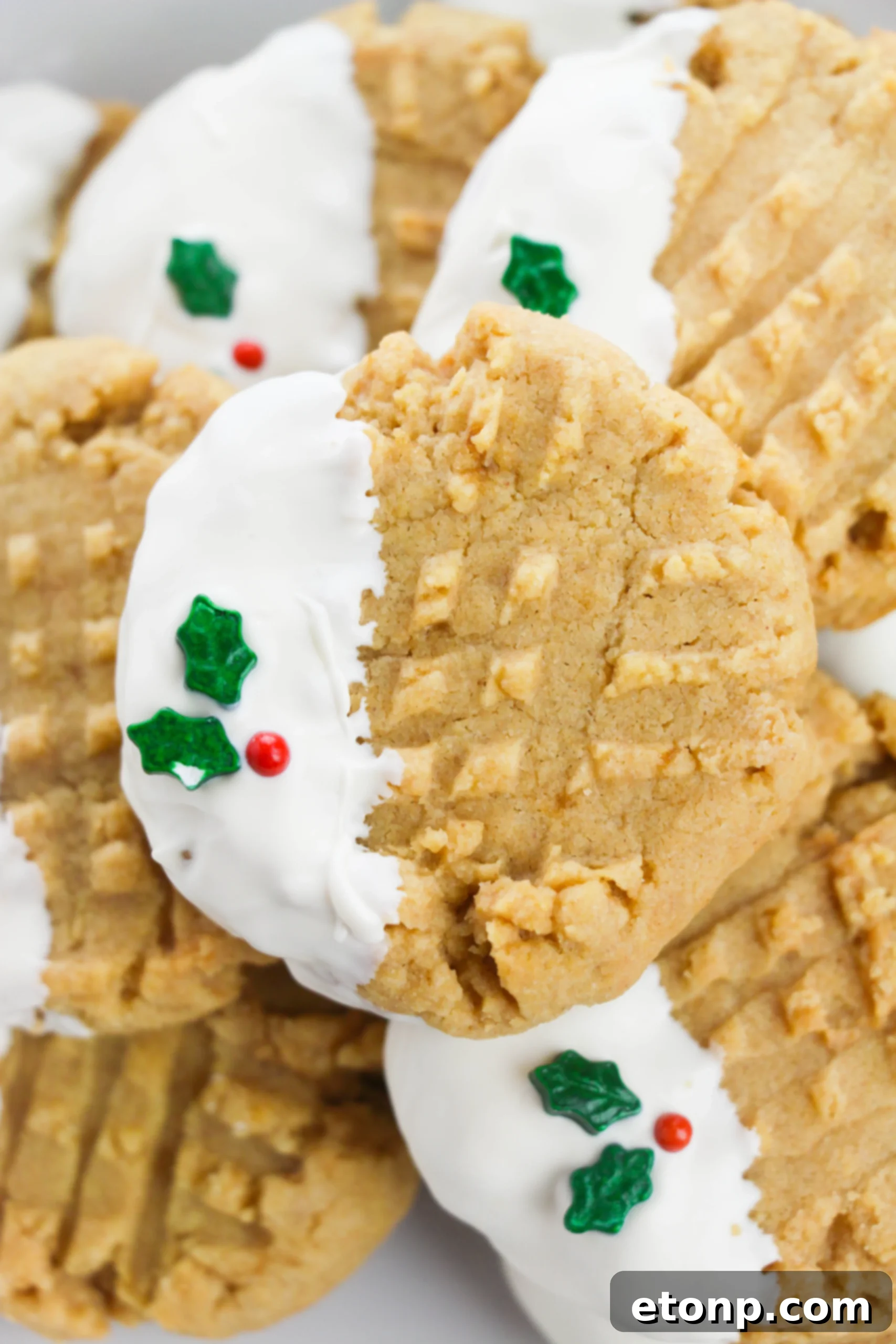 Silky White Chocolate Peanut Butter Cookies 2 Close-up of a white chocolate dipped peanut butter cookie with festive sprinkles
