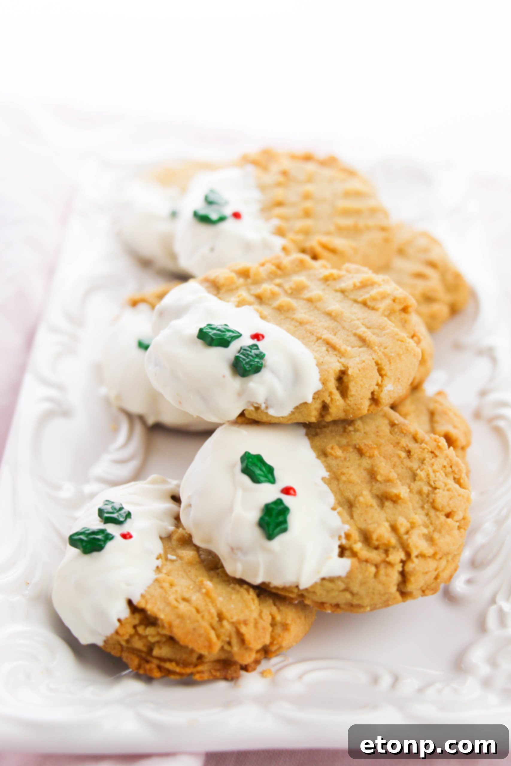 Silky White Chocolate Peanut Butter Cookies 6 Arrangement of white chocolate dipped peanut butter cookies on a festive background