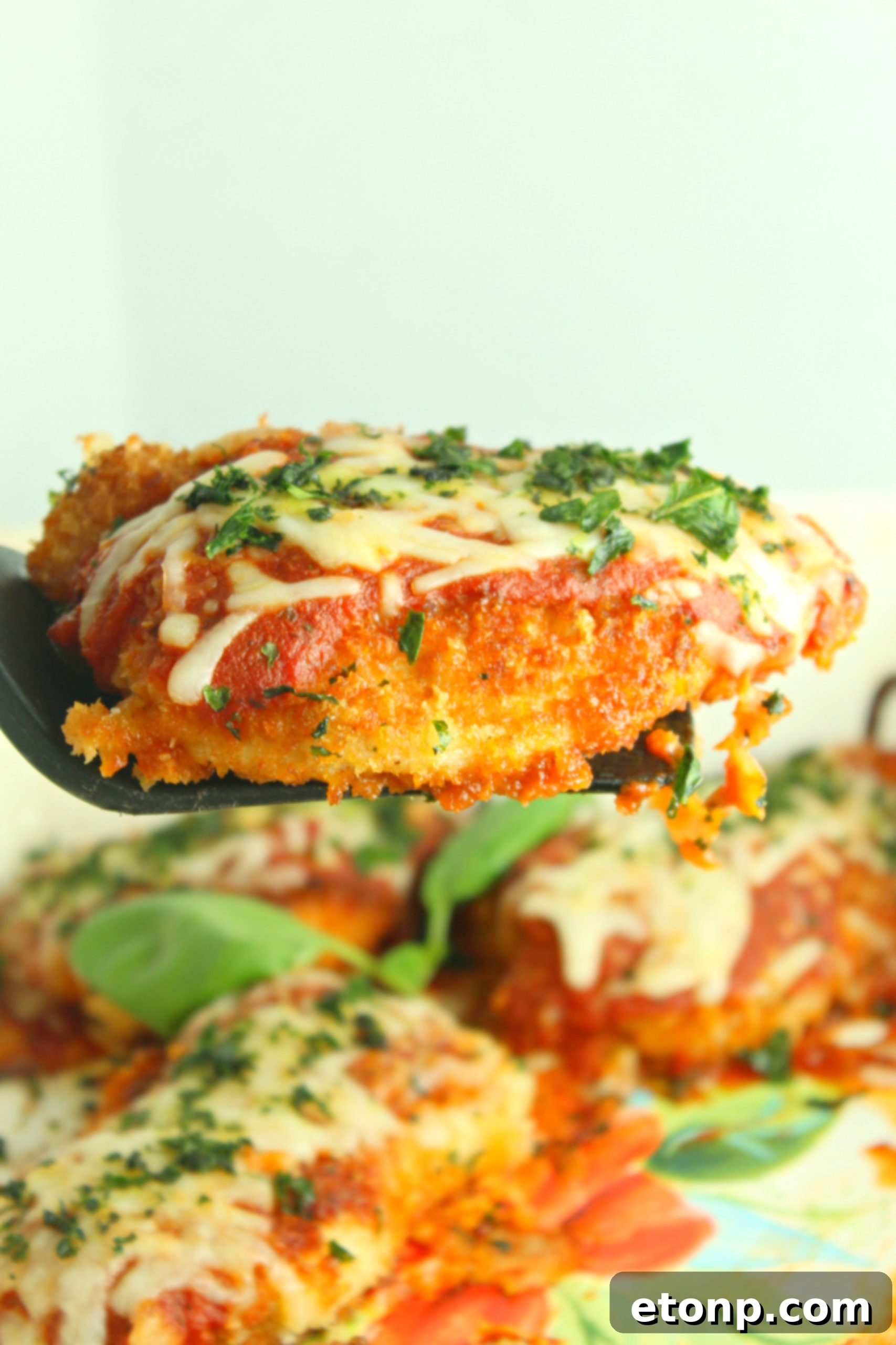Crispy, Cheesy Chicken Parmesan 11 Frying breaded chicken in a hot skillet