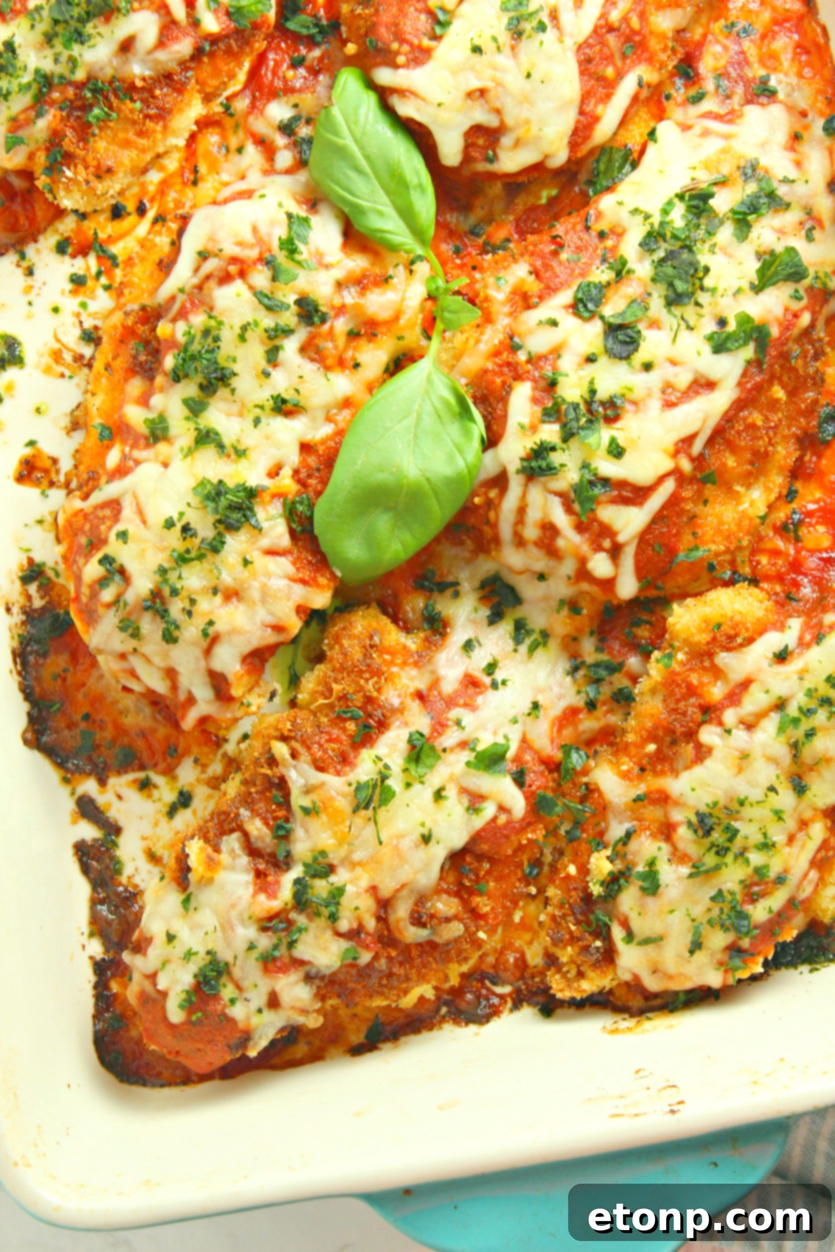 Crispy, Cheesy Chicken Parmesan 3 Close-up of baked chicken parmesan with cheese melting