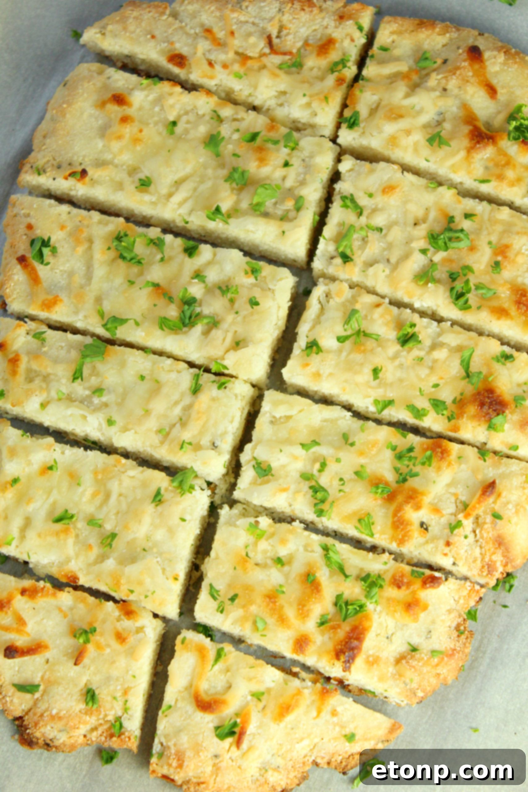 Four Cheese Keto Breadsticks Deliciously Low Carb 8 Ingredients for Four Cheese Keto Breadsticks laid out: shredded cheese, cream cheese, almond flour, coconut flour, egg, Italian seasoning, and fresh parsley.