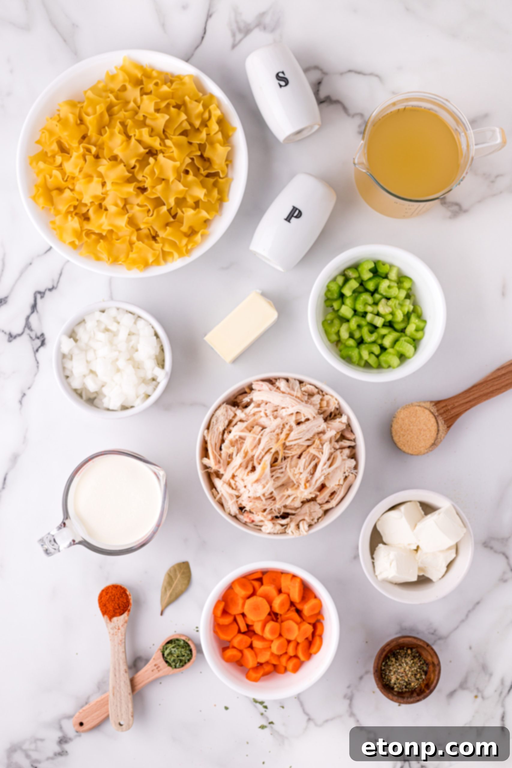 Close-up of creamy chicken noodle soup with chunks of chicken and vegetables, ready to be served.