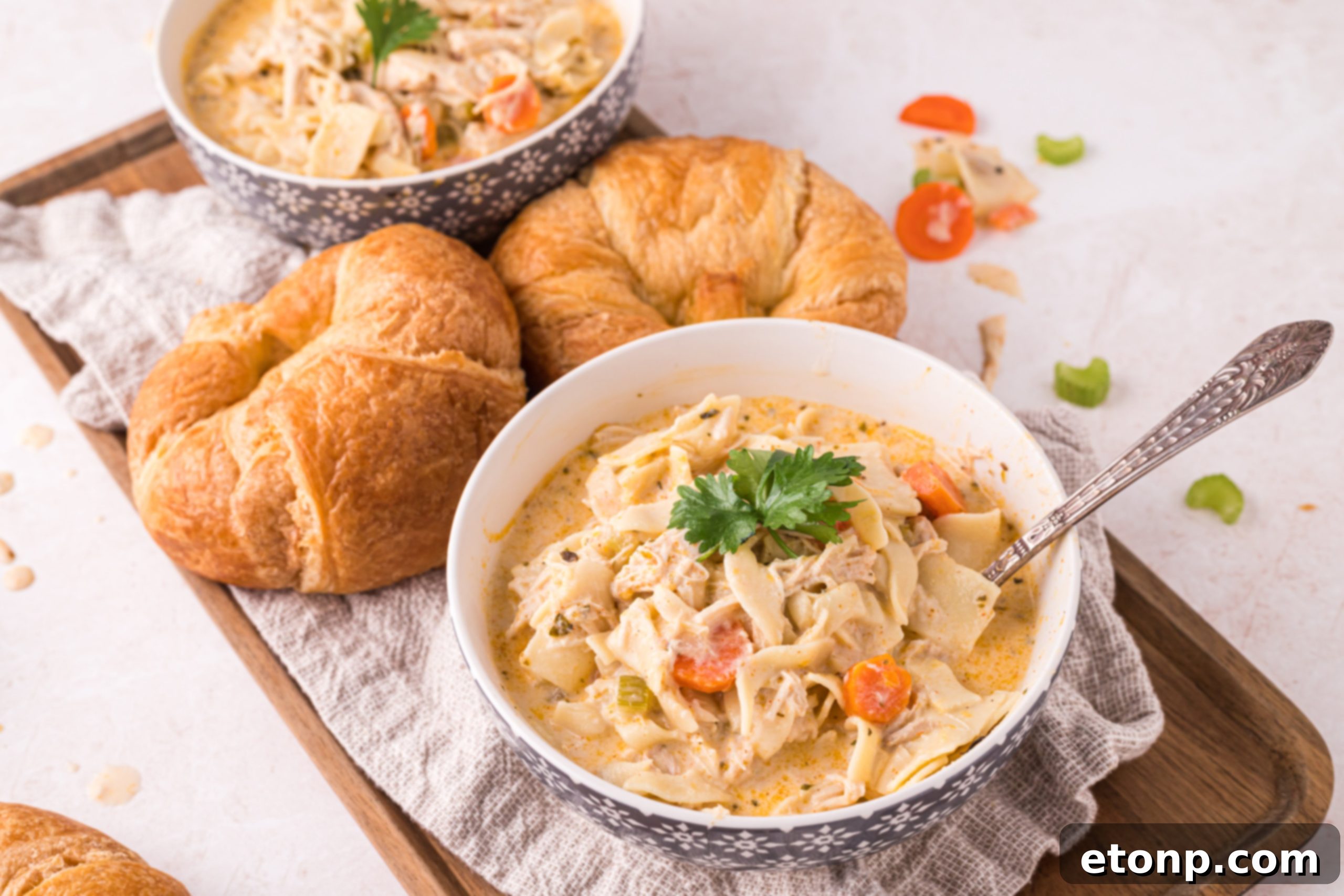 Containers of creamy chicken noodle soup prepared for freezing or refrigeration.
