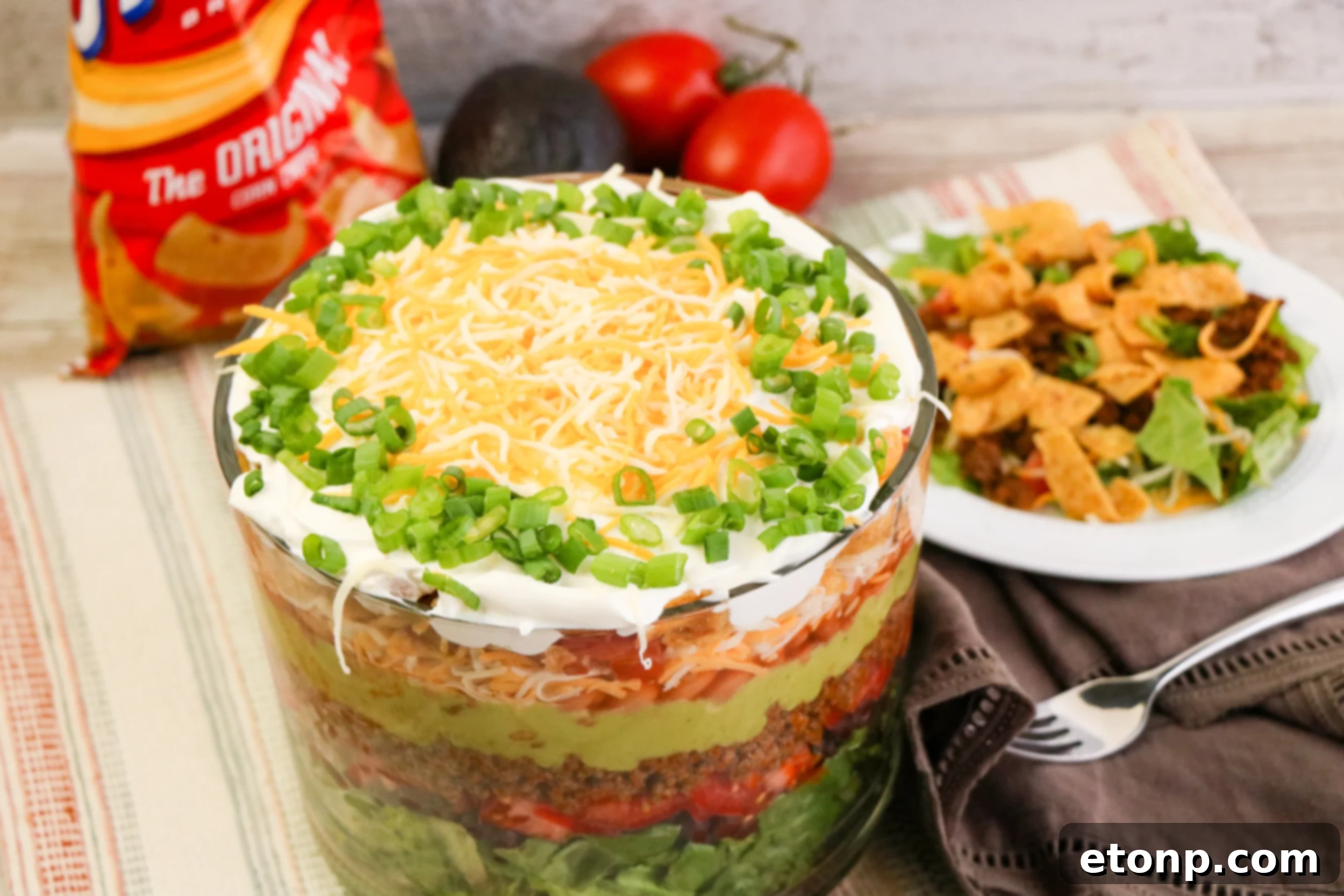 Ingredients neatly arranged for a layered Mexican salad