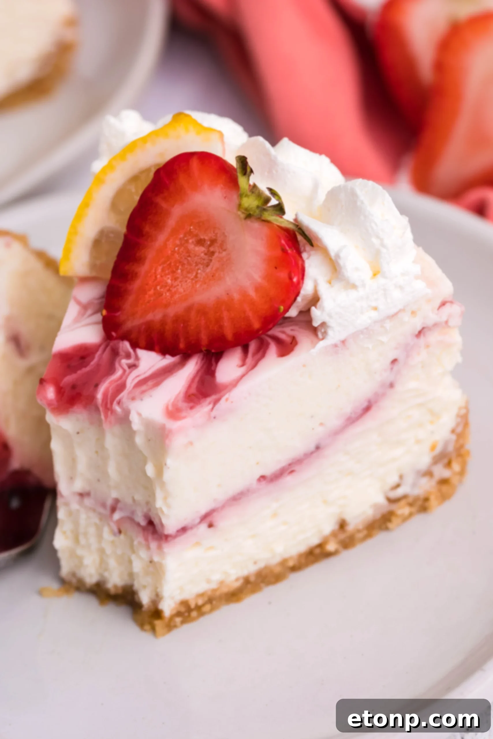 An inviting display of all the essential ingredients meticulously laid out for crafting the Strawberry Lemon RumChata Cheesecake, including softened cream cheese, crunchy Nilla Wafers, fresh strawberries, and a bottle of Limon RumChata.