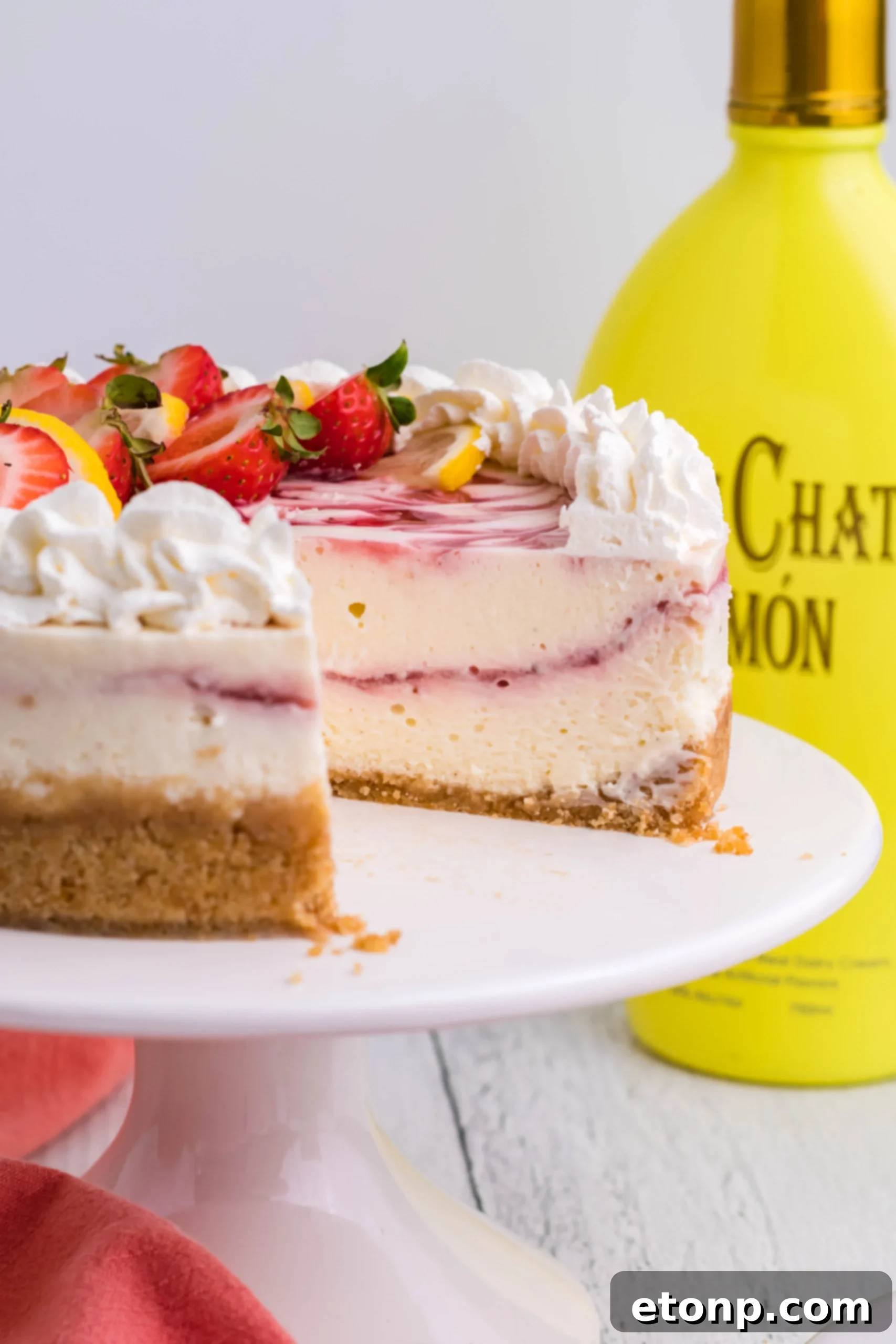 A pristine close-up shot of a perfectly cooked Instant Pot Strawberry Lemon RumChata Cheesecake, showcasing its impeccably smooth surface and light golden hue before any toppings are added.