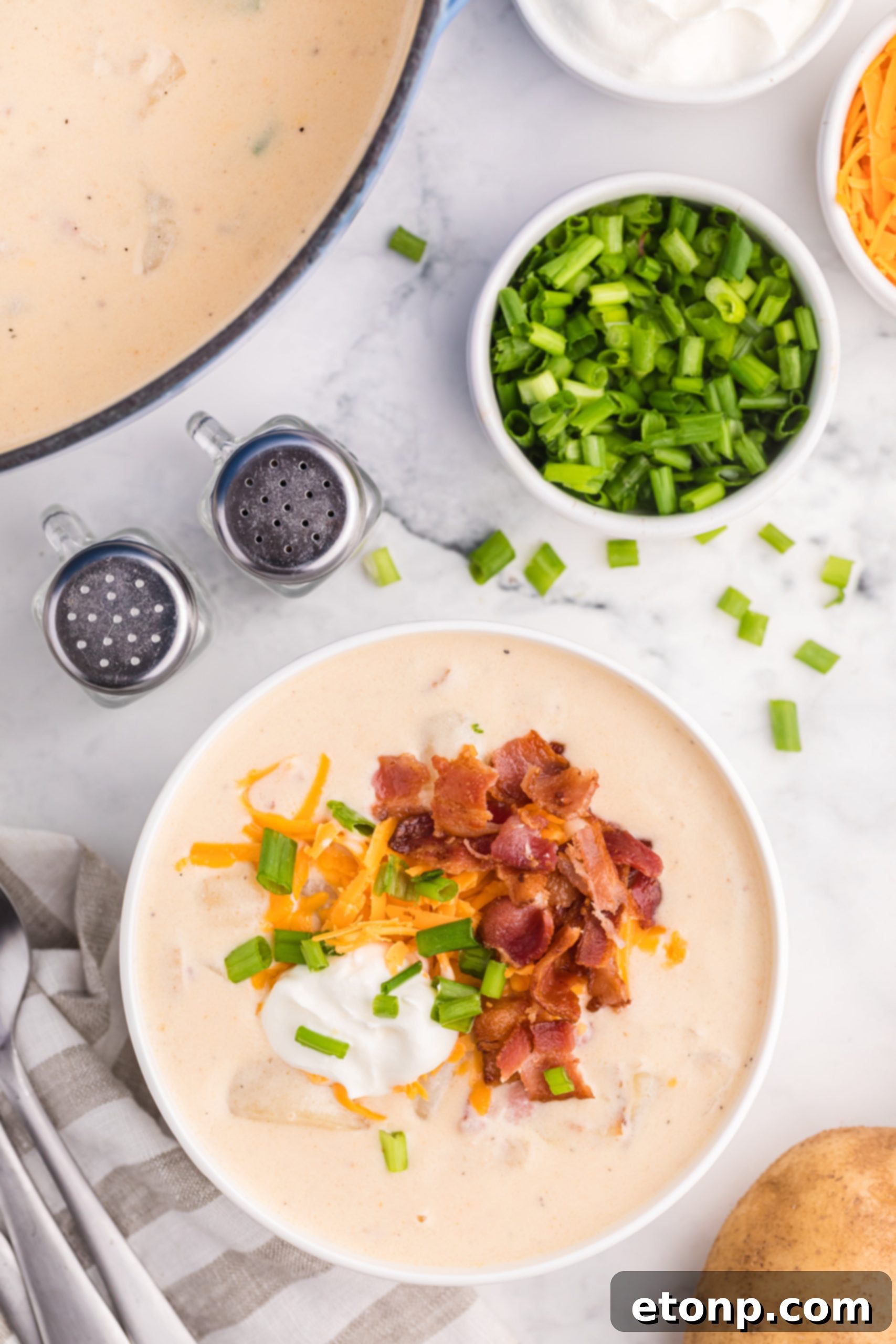 Rich and creamy Loaded Baked Potato Soup in a rustic bowl