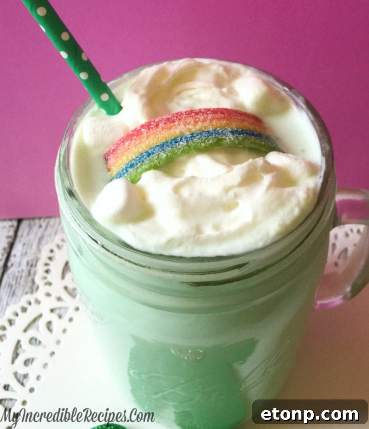 Rich green Shamrock Cocoa in a glass with whipped cream and candy garnish