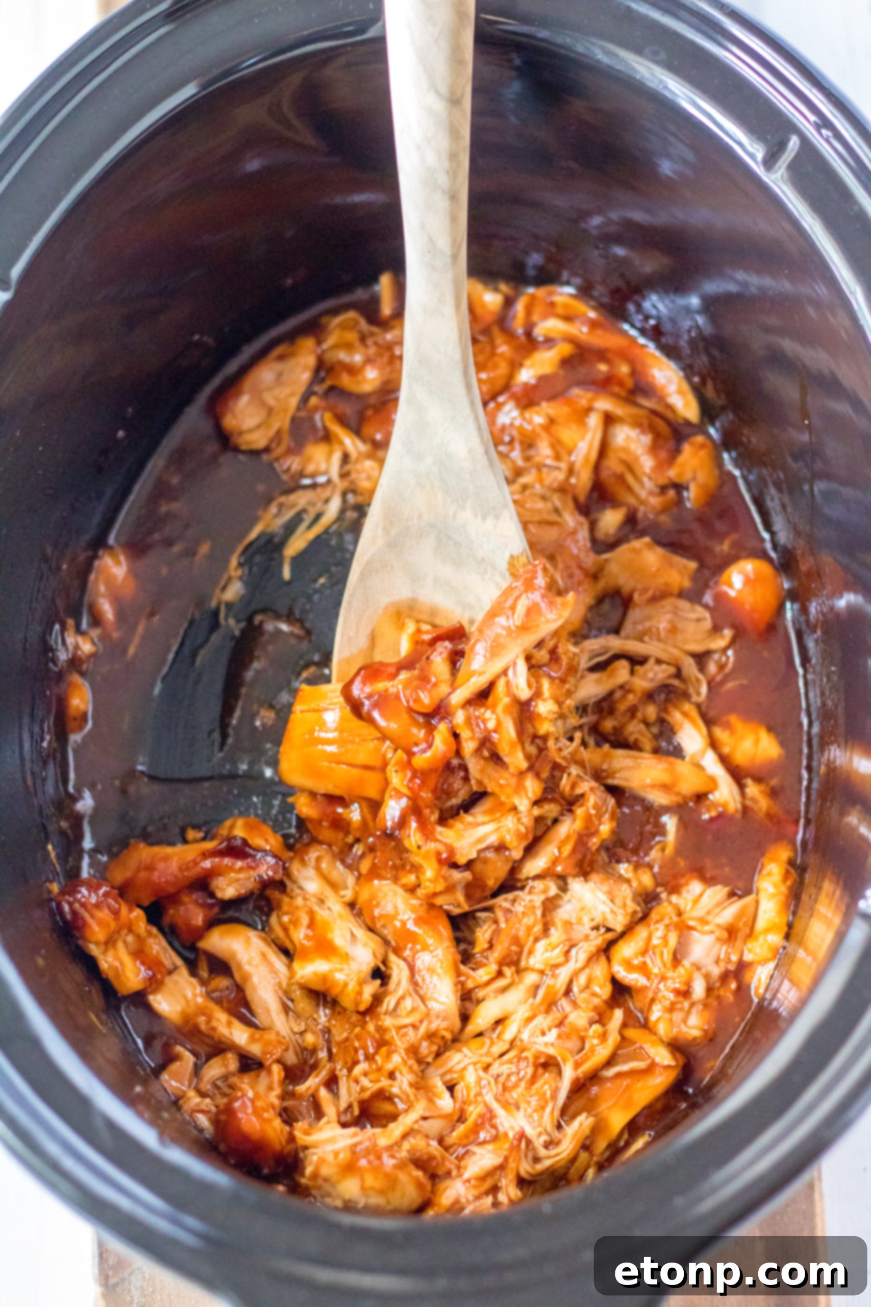 Slow Cooker Root Beer Chicken served on a bun with cheese