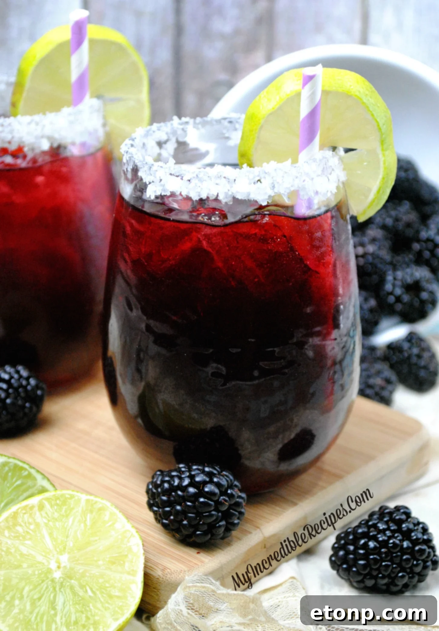 A beautifully crafted Blackberry Margarita, showcasing its rich purple hue and fresh blackberry garnish.
