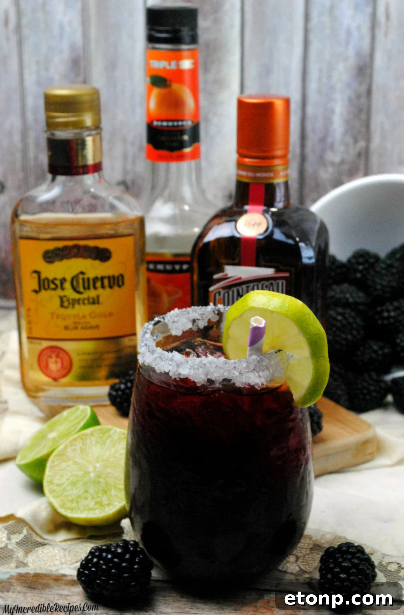 Multiple Blackberry Margaritas lined up, showcasing their rich color and garnishes.