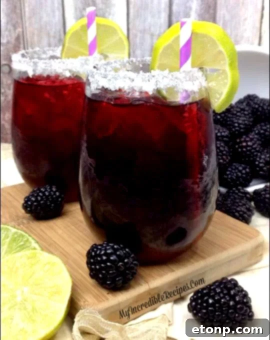 A close-up of a margarita glass with a sparkling sugared rim.