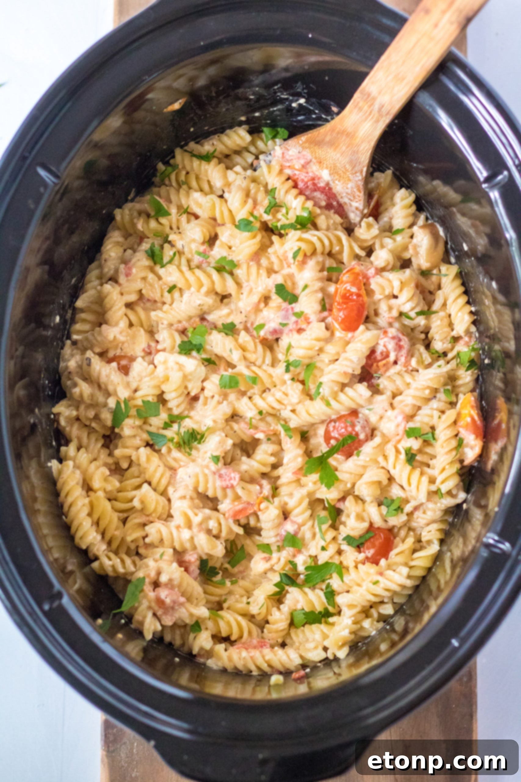 Slow Cooker Tomato Feta Pasta in a ceramic slow cooker
