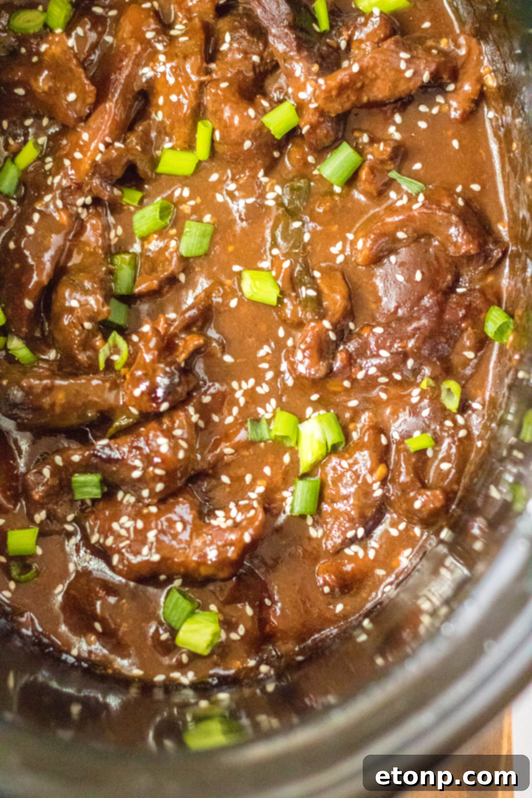 Slow Cooker Mongolian Beef served in a bowl with rice