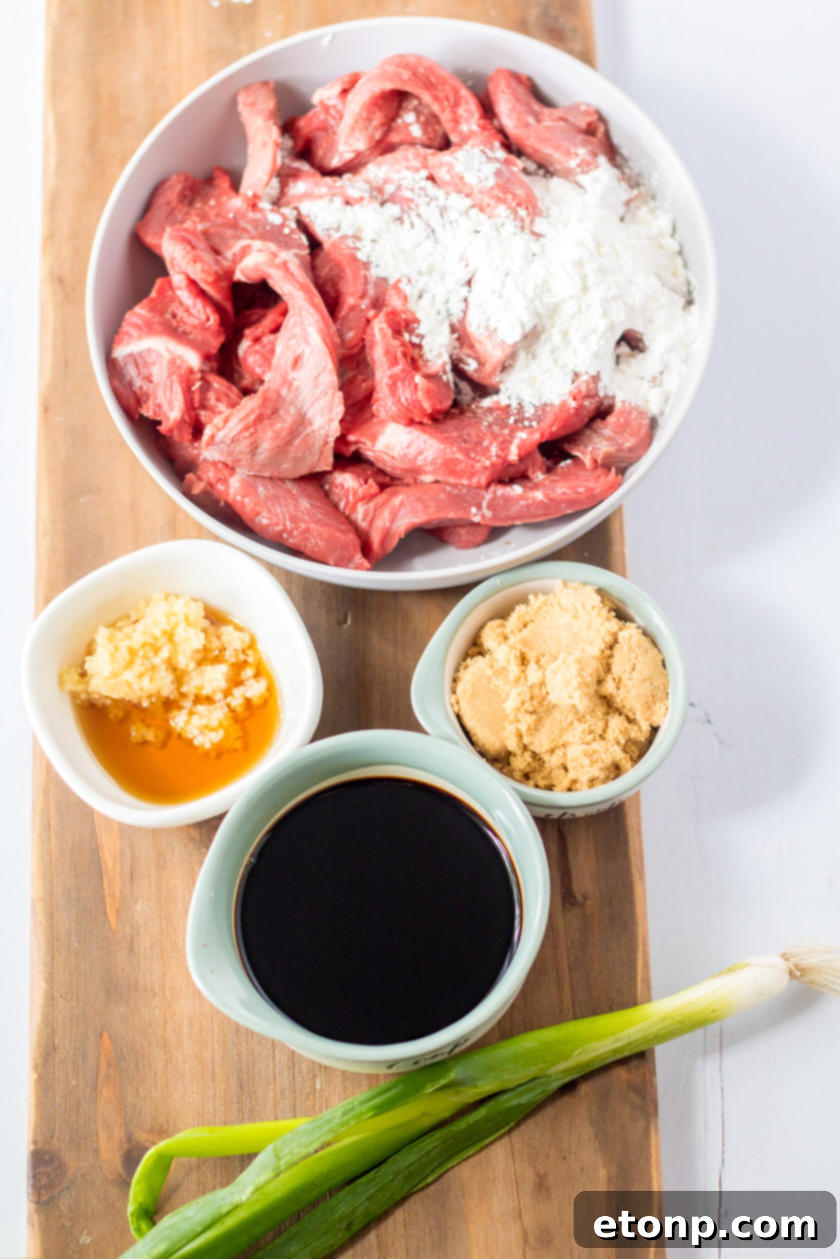 Close-up of Slow Cooker Mongolian Beef with green onions and sesame seeds