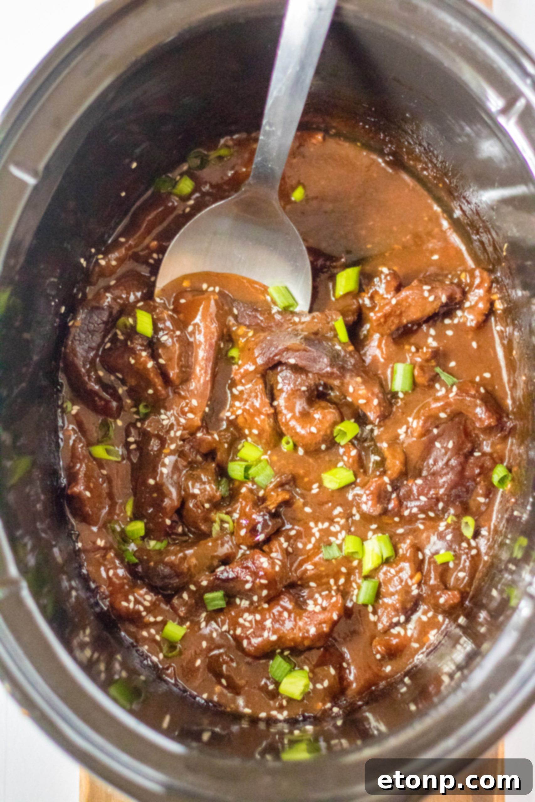 Thinly sliced beef, coated in cornstarch, ready for slow cooker