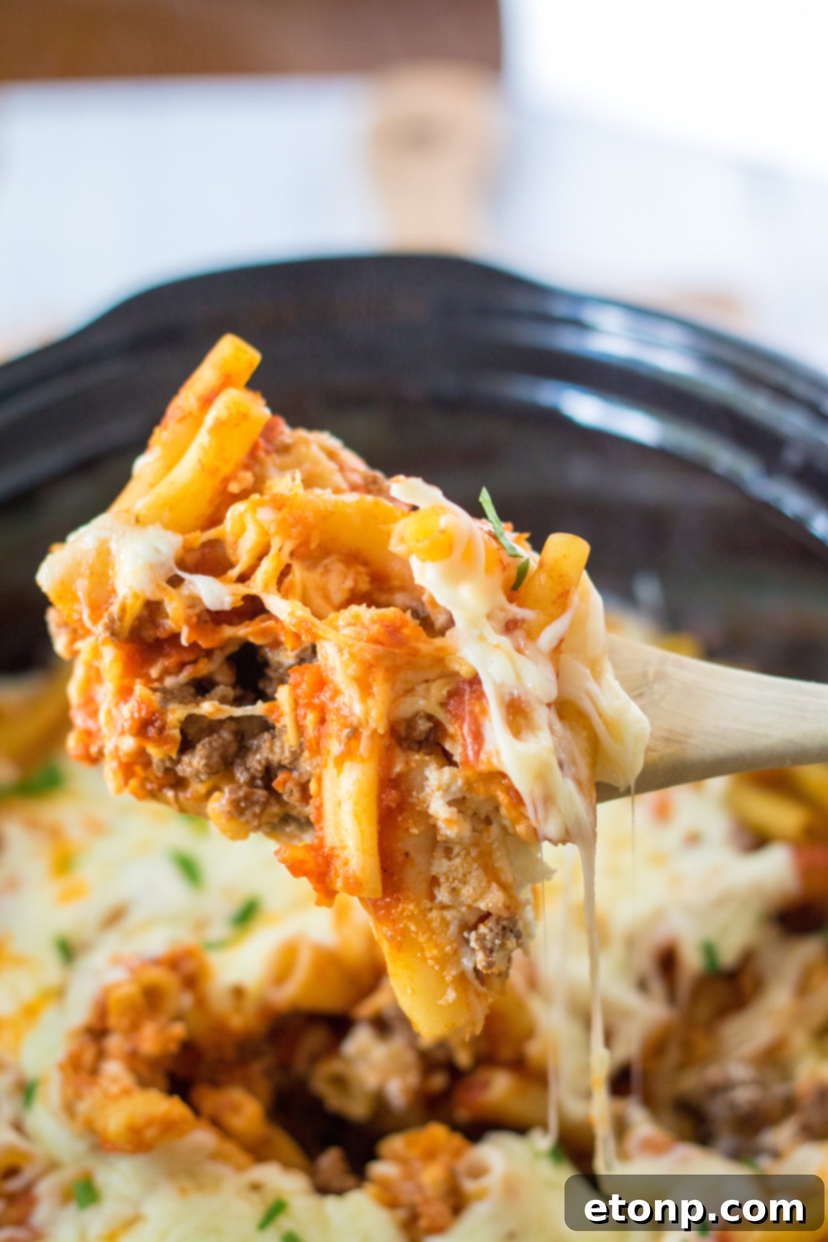 Serving of Slow Cooker Cheesy Baked Pasta on a plate, showing the creamy texture and melted cheese.
