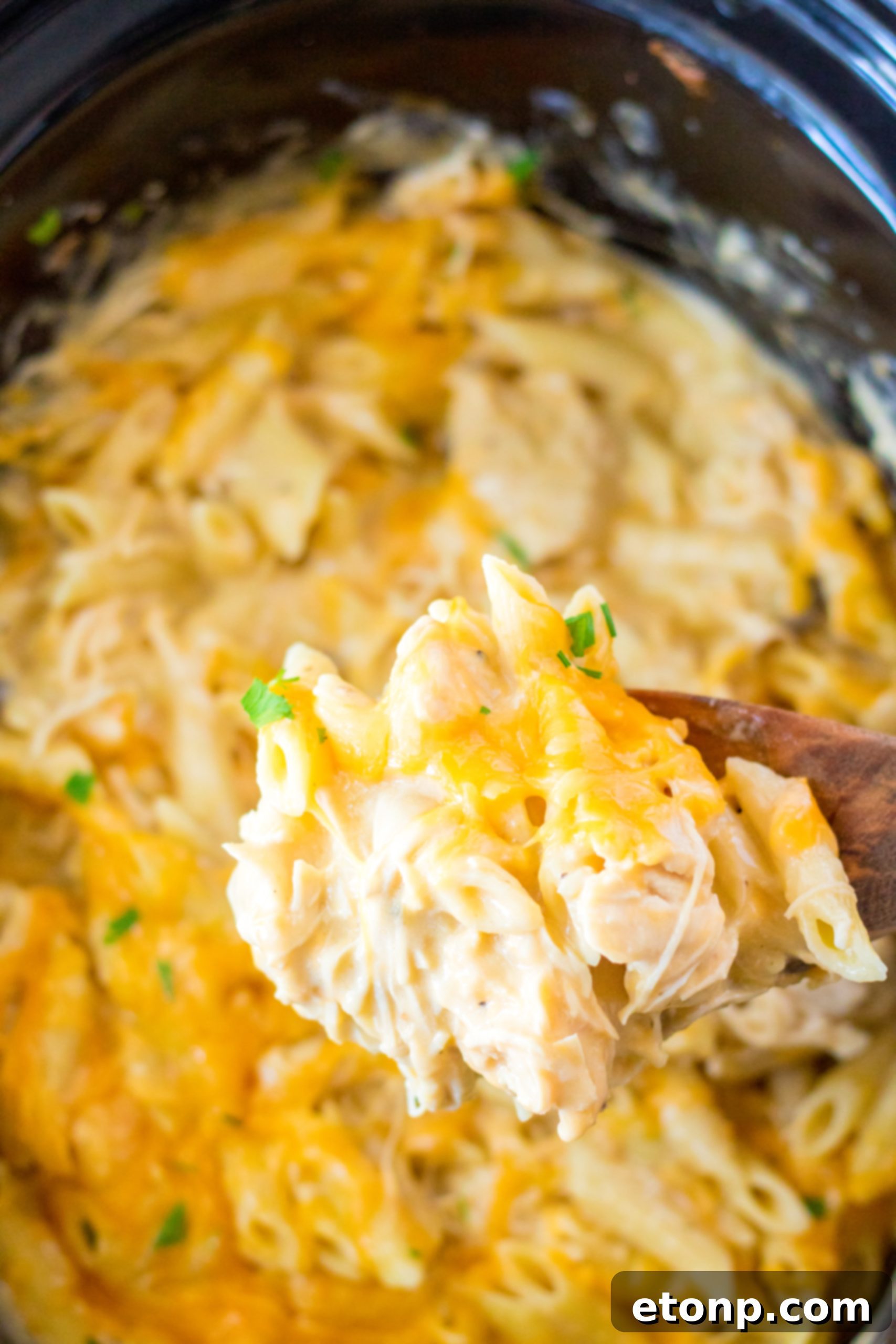 Effortless Slow Cooker Cheesy Chicken Penne 2 Delicious Slow Cooker Cheesy Chicken Penne in a crock pot, ready to be served