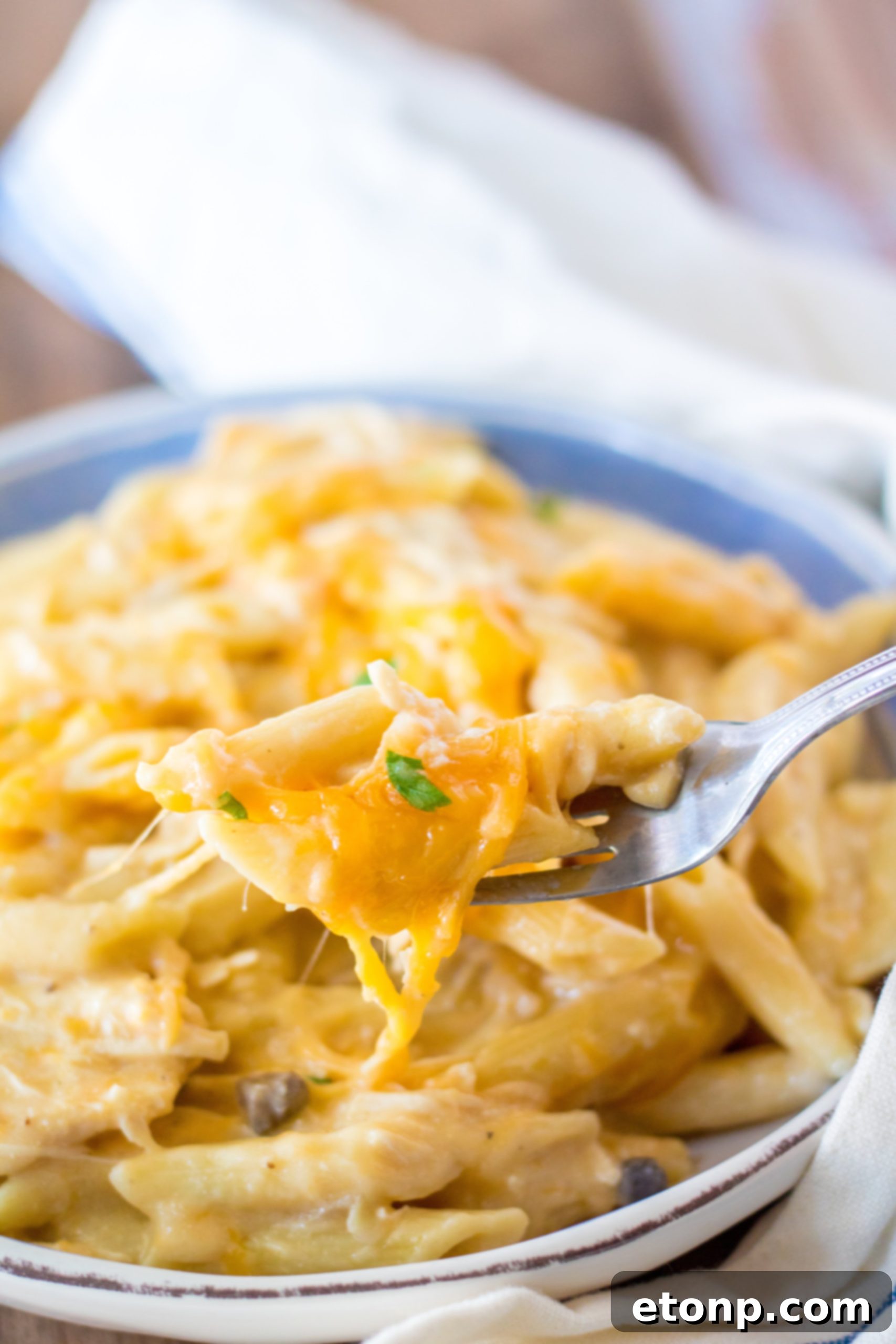 Effortless Slow Cooker Cheesy Chicken Penne 5 A slow cooker filled with chicken, soup mixture, and diced onions, ready to cook