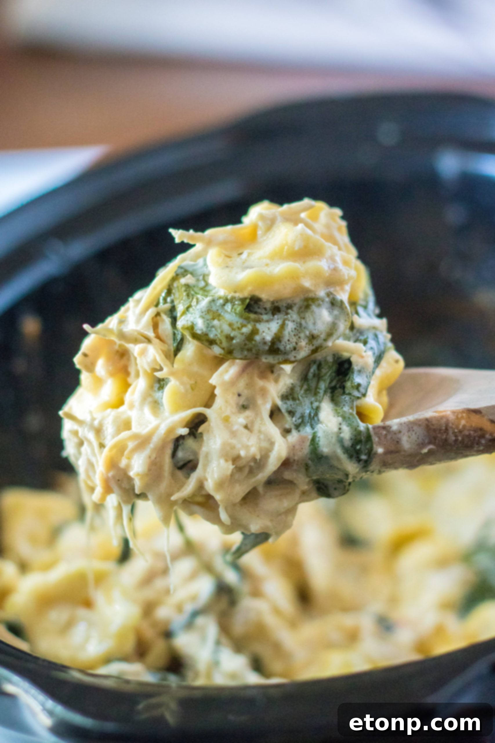 Cooked tortellini pasta waiting to be added to a sauce.