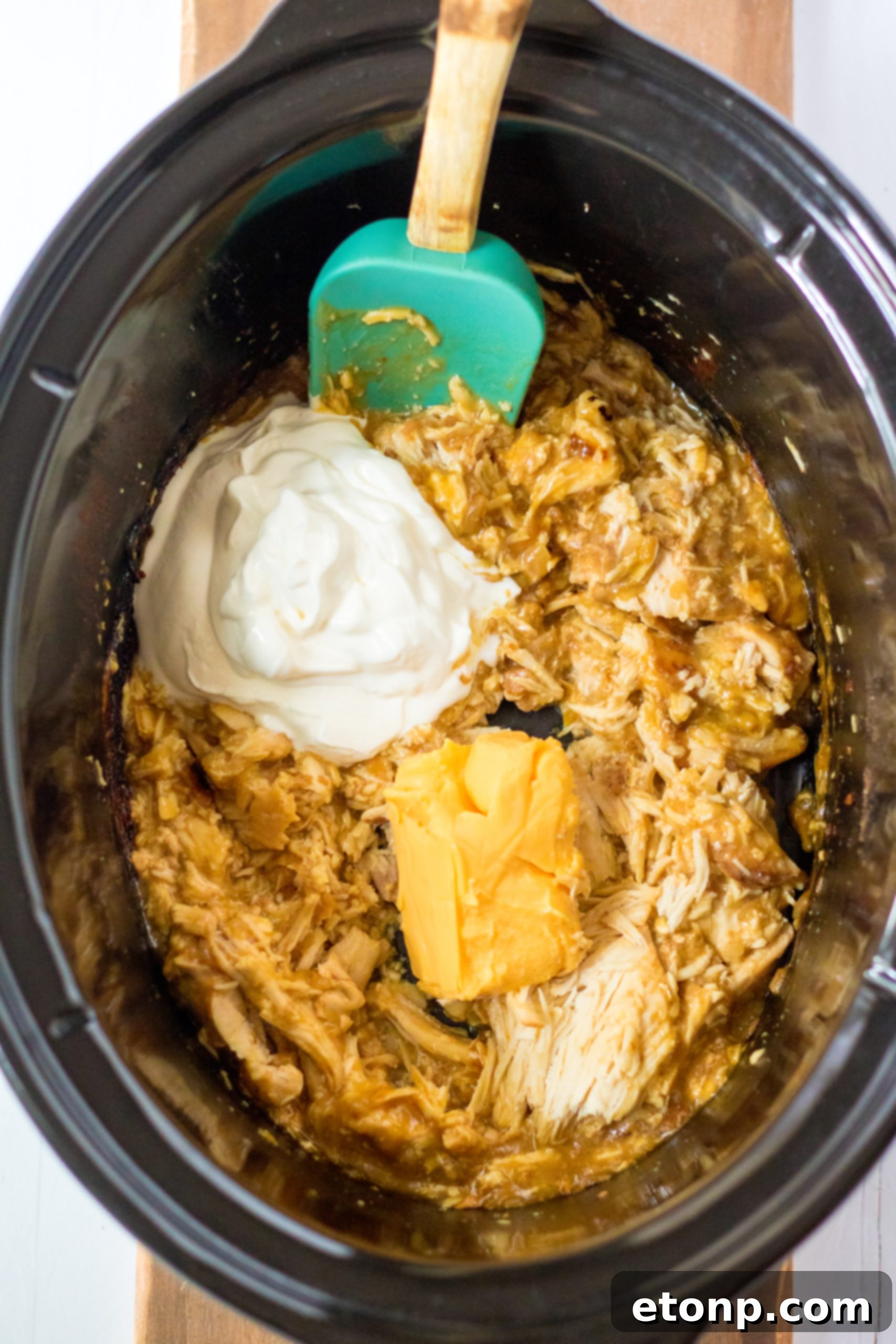 Close-up of the creamy, cheesy texture of Slow Cooker Cheesy Chicken and Rice.