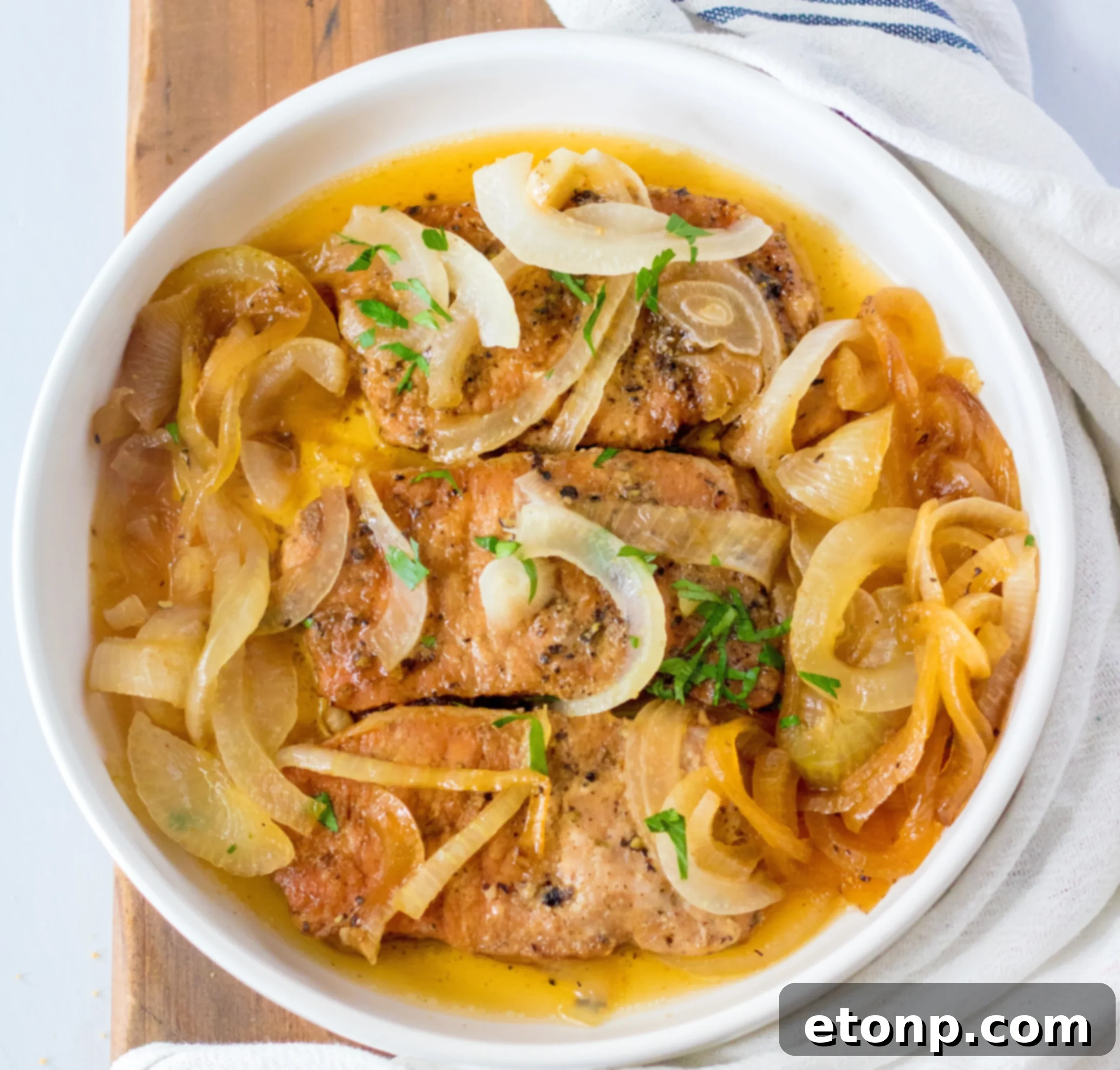 Tender Slow Cooker Pork Chops with Sweet Onions 11 Slow cooker pork chops and onions plated with rice