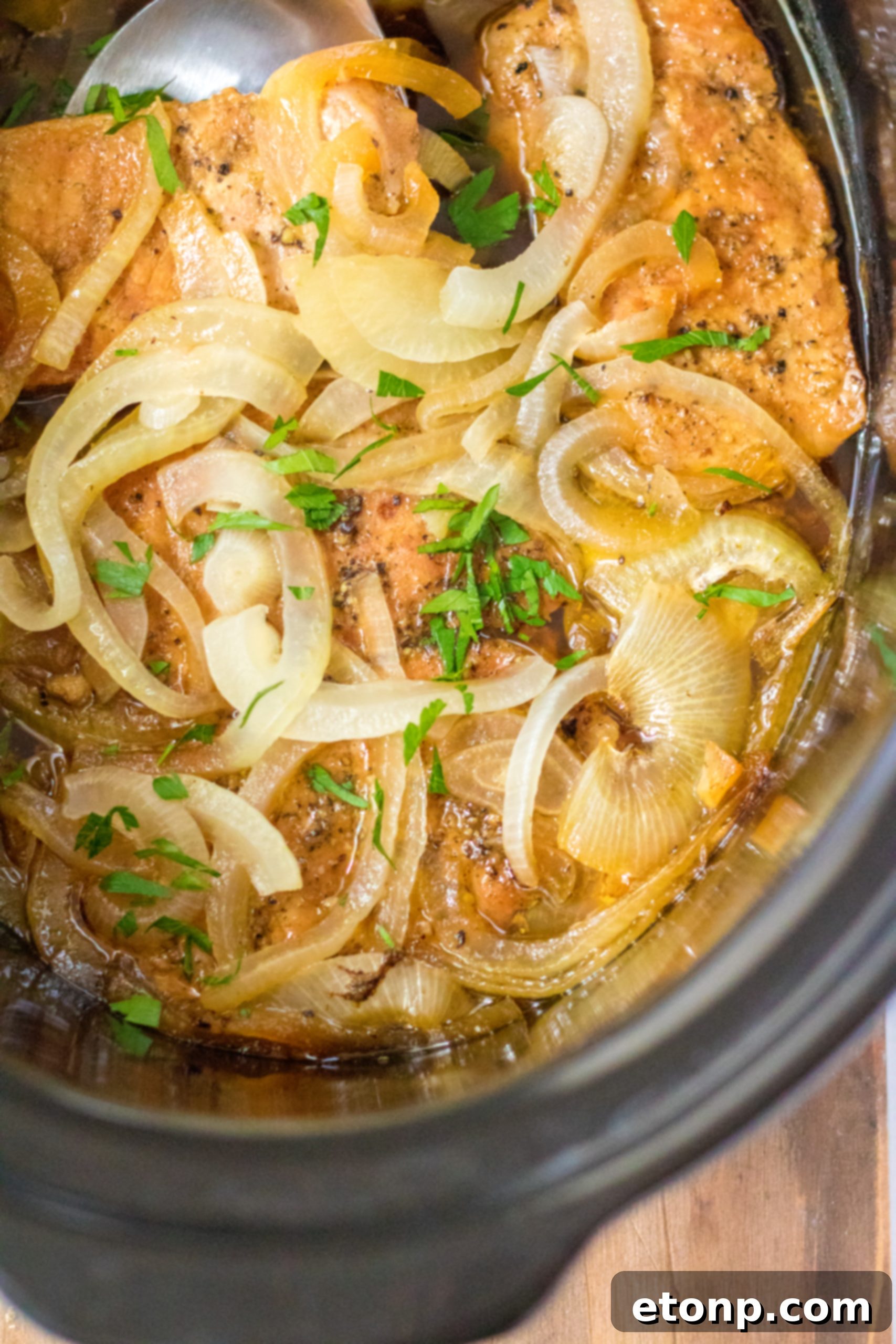 Tender Slow Cooker Pork Chops with Sweet Onions 10 Slow cooker pork chops cooking on low