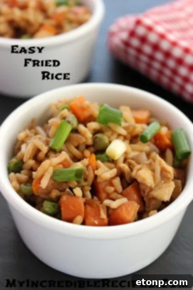 Close-up of freshly made fried rice with vegetables and egg in a skillet.