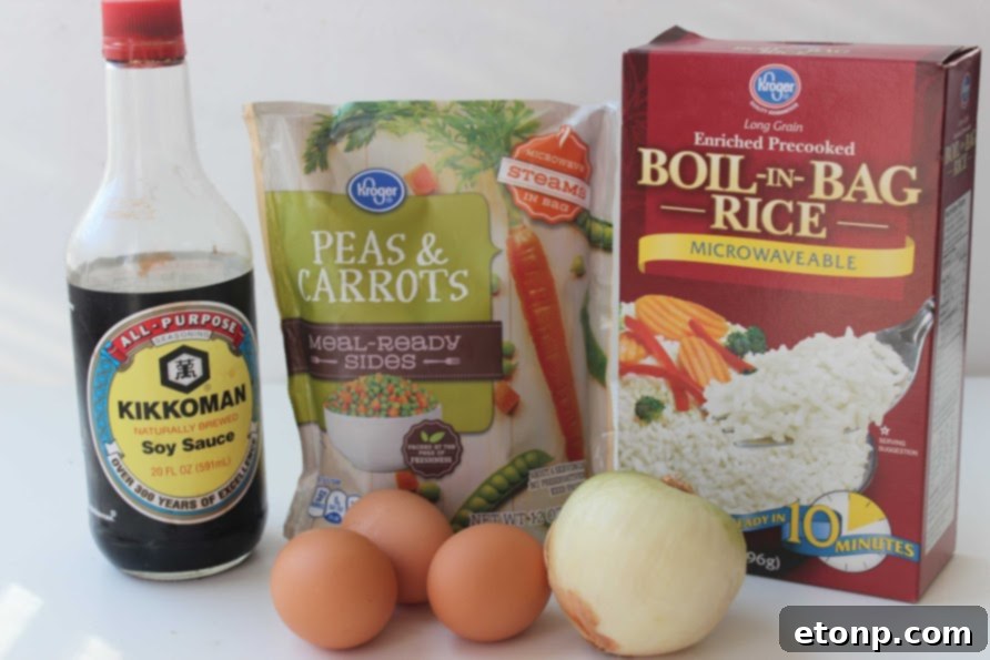 Ingredients for making homemade fried rice laid out on a cutting board.