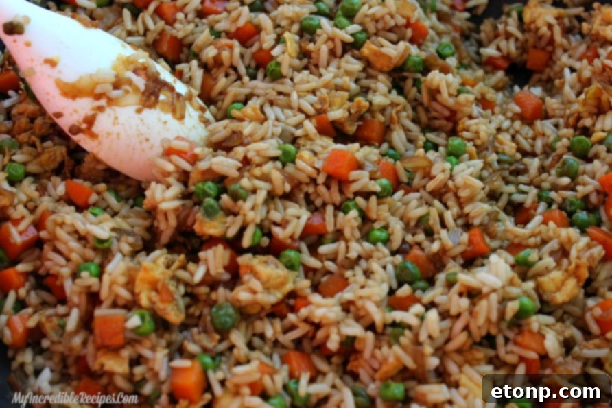 A large skillet full of perfectly cooked homemade fried rice, ready to serve.