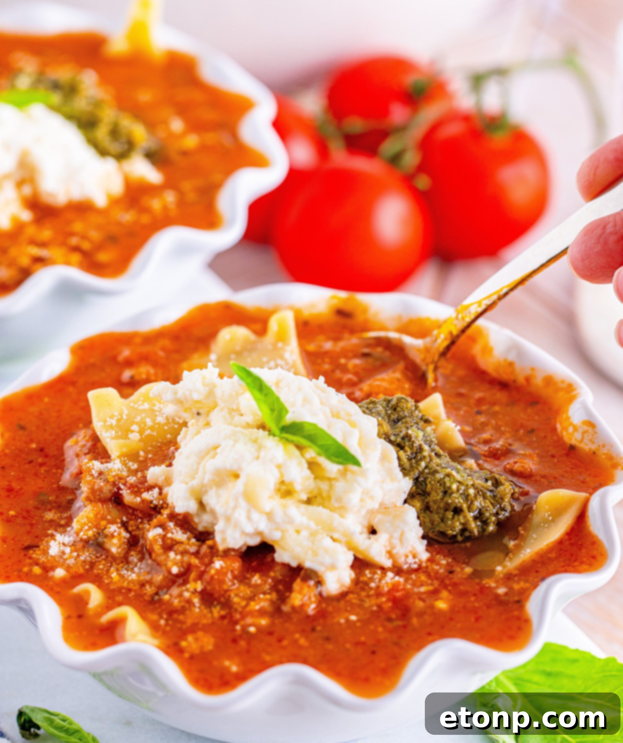 A large pot of Lasagna Soup with a serving ladle, ready to be dished out.