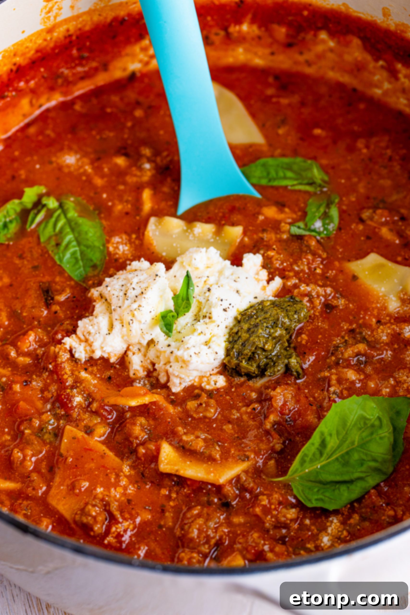 Lasagna Soup in a bowl with fresh basil leaves as garnish.