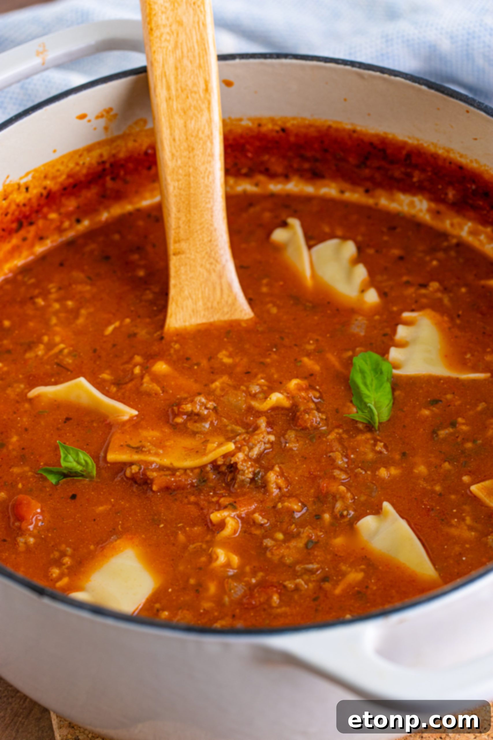 Lasagna Soup in a Dutch oven, simmering with all ingredients.
