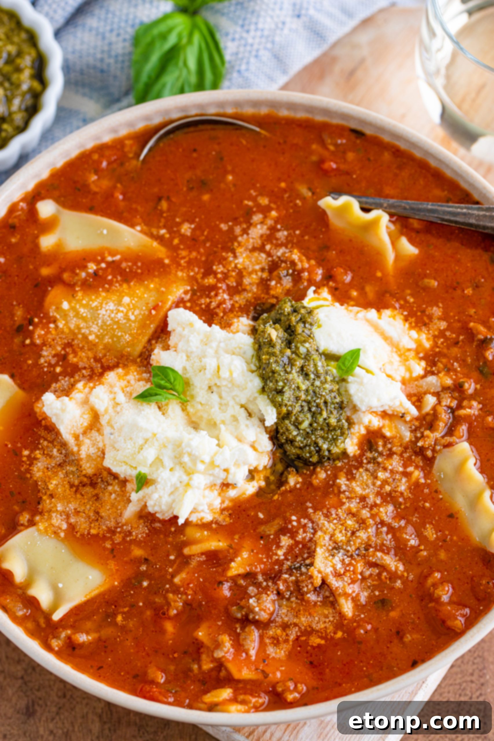 A bowl of Lasagna Soup with bread on the side, ready to be enjoyed.